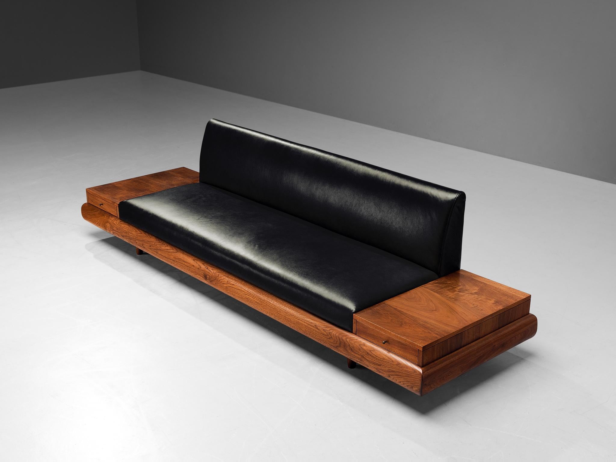Adrian Pearsall, 'Platform' sofa with two drawers, model 1709-S, leather upholstery, walnut, United States, 1960s

Adrian Pearsall is known for his rather unique sofa designs. The '1709-S' is no exception. On a low base of a thick walnut frame rests
