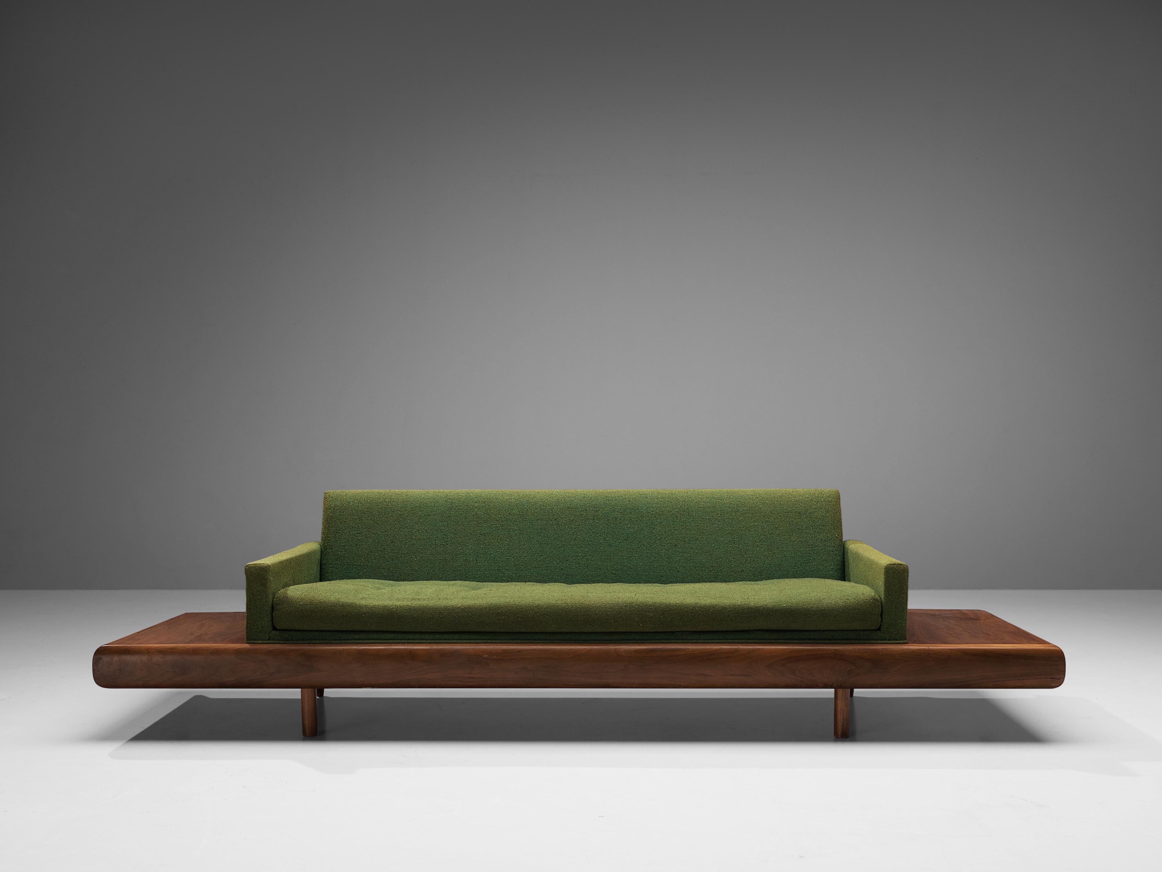 Adrian Pearsall, 'Platform' sofa, fabric, walnut, United States, 1960s

Adrian Pearsall is known for his rather unique sofa designs. This one is no exception. On a low base of a thick walnut frame rests the sofa, which continues, resulting in side
