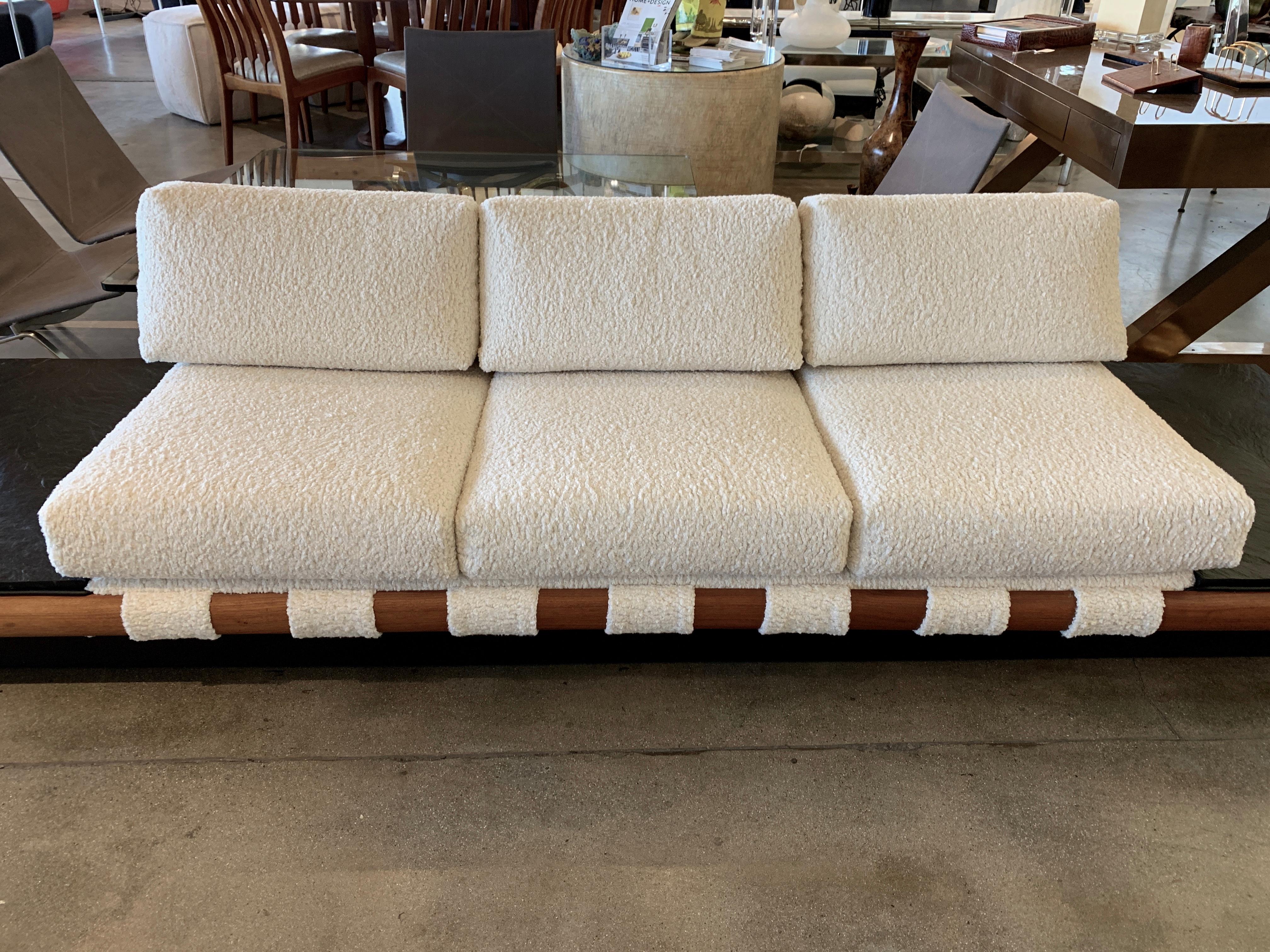 A vintage 1960s Adrian Pearsall platform sofa re-upholstered in a Kravet Faux Shearling fabric. The ends are set in pieces of slate. The black platform base has been repainted and retouched. The wood frame has some imperfections with age appropriate