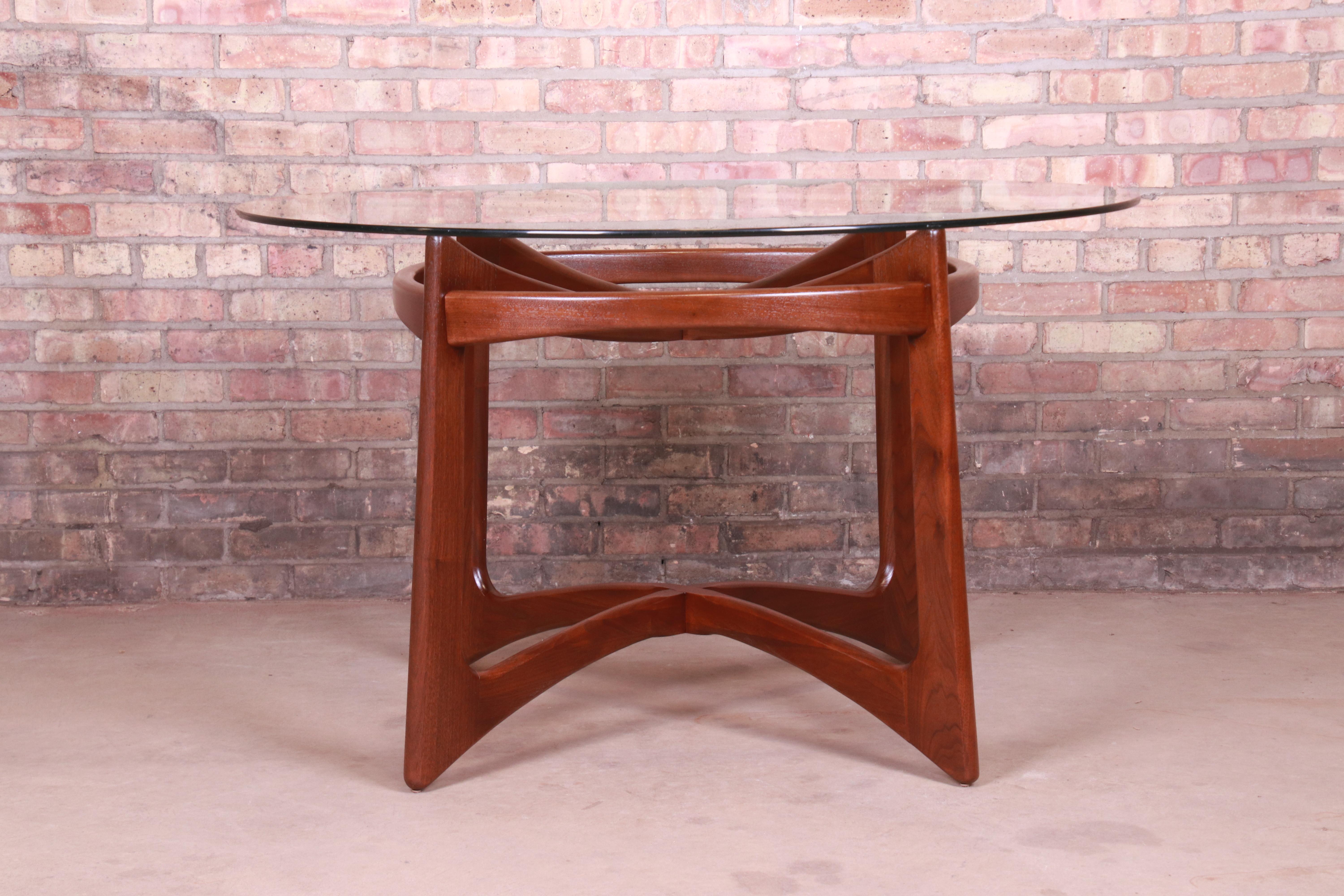 A gorgeous Mid-Century Modern dining or game table

By Adrian Pearsall

USA, 1960s

Sculpted walnut base, with round glass top.

Measures: 48