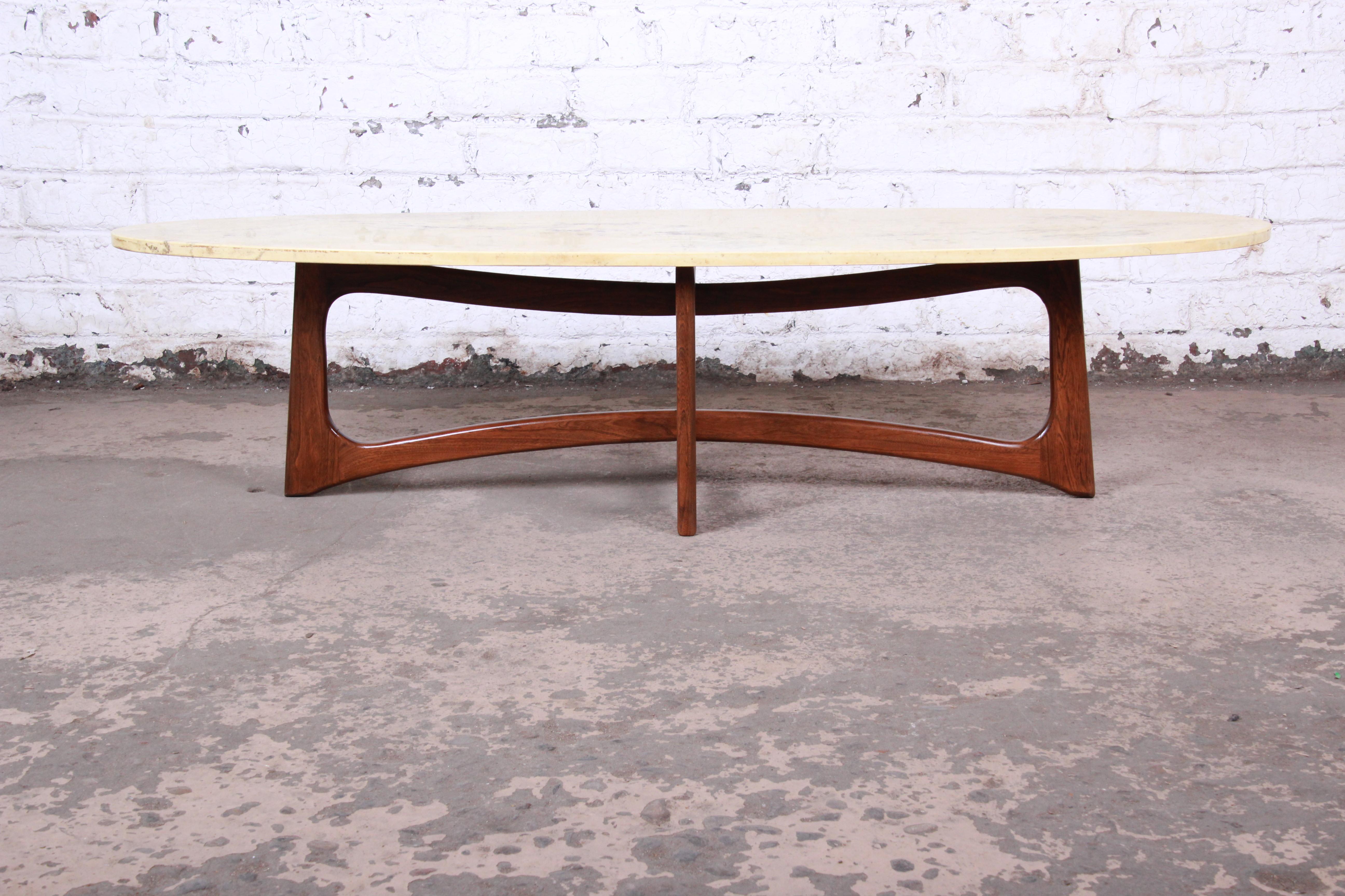 A gorgeous Mid-Century Modern surfboard coffee or cocktail table

By Adrian Pearsall for Craft Associates

USA, 1960s

Sculpted walnut base and marble top

Measures: 64.13