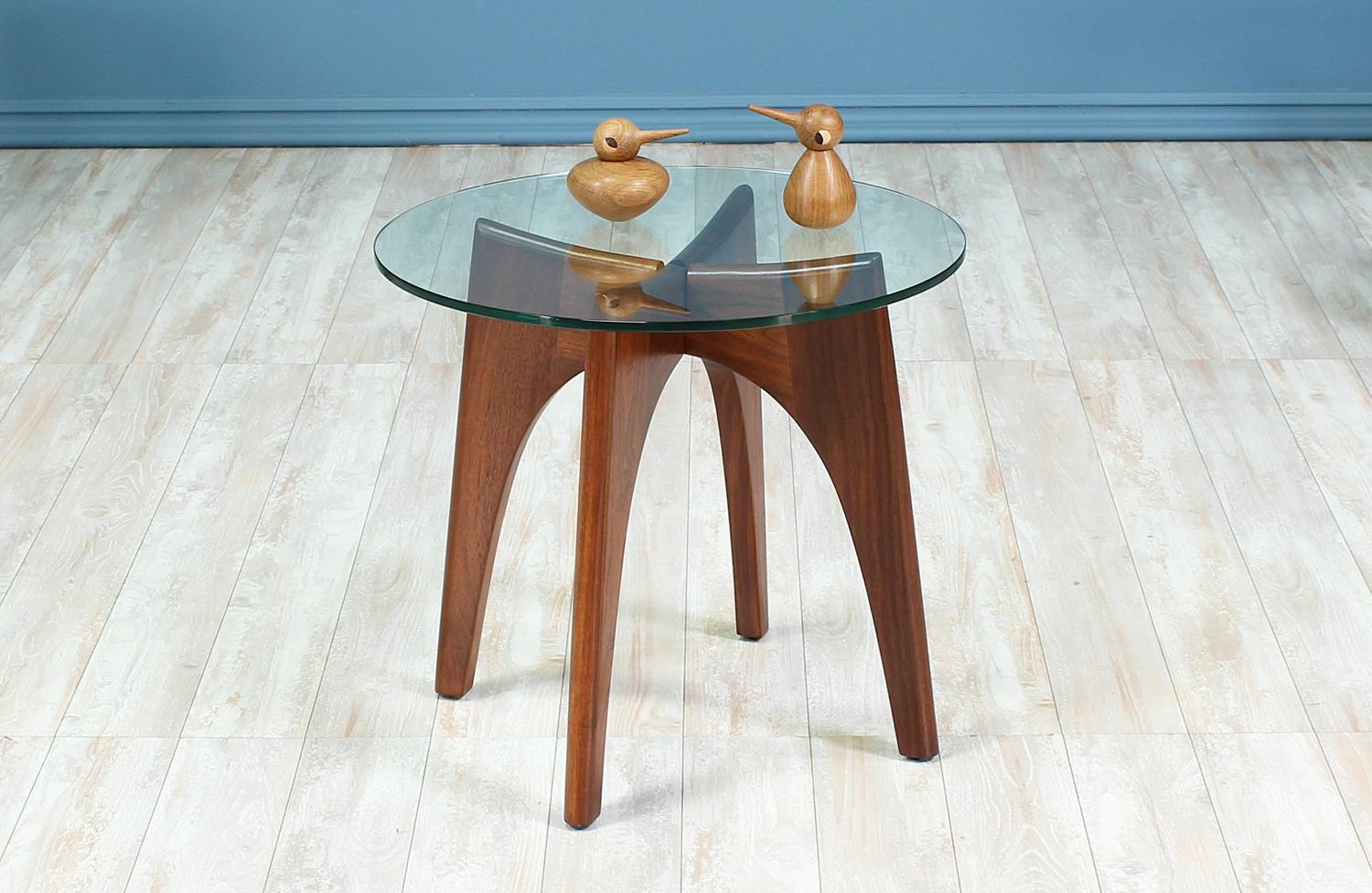 Side table designed by Adrian Pearsall for Craft Associates in the United States circa 1960’s. This beautiful table features an interlocked “X” shaped walnut wood base visible through the new glass top. The versatility of this table allows it to be