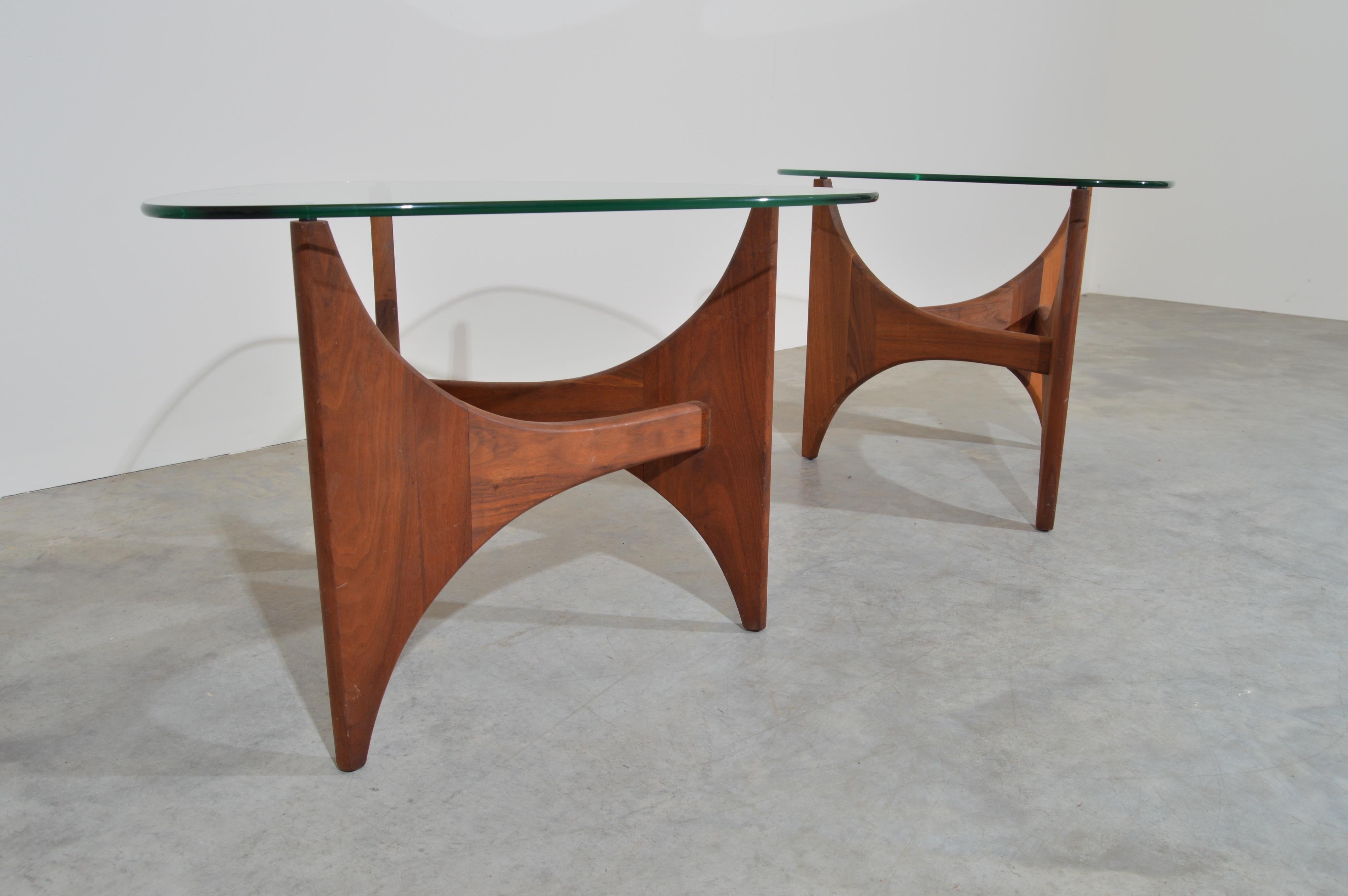 A pair of mid-century sculptural walnut side tables having original guitar pick glass tops designed by Adrian Pearsall. 
Beautiful overall condition. Minor signs of usage to glass tops. Nothing major. Solid and stable. Clean and ready for use!