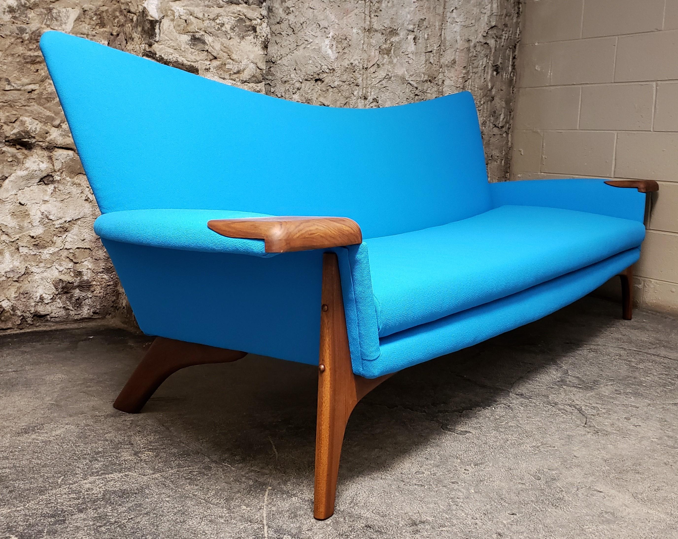 Mid-Century Modern sofa designed by Adrian Pearsall for Craft Associates. The modernist form has been newly upholstered in a striking Maharam fabric. It also features walnut accents on the arms as well as a walnut frame with rich and vibrant wood