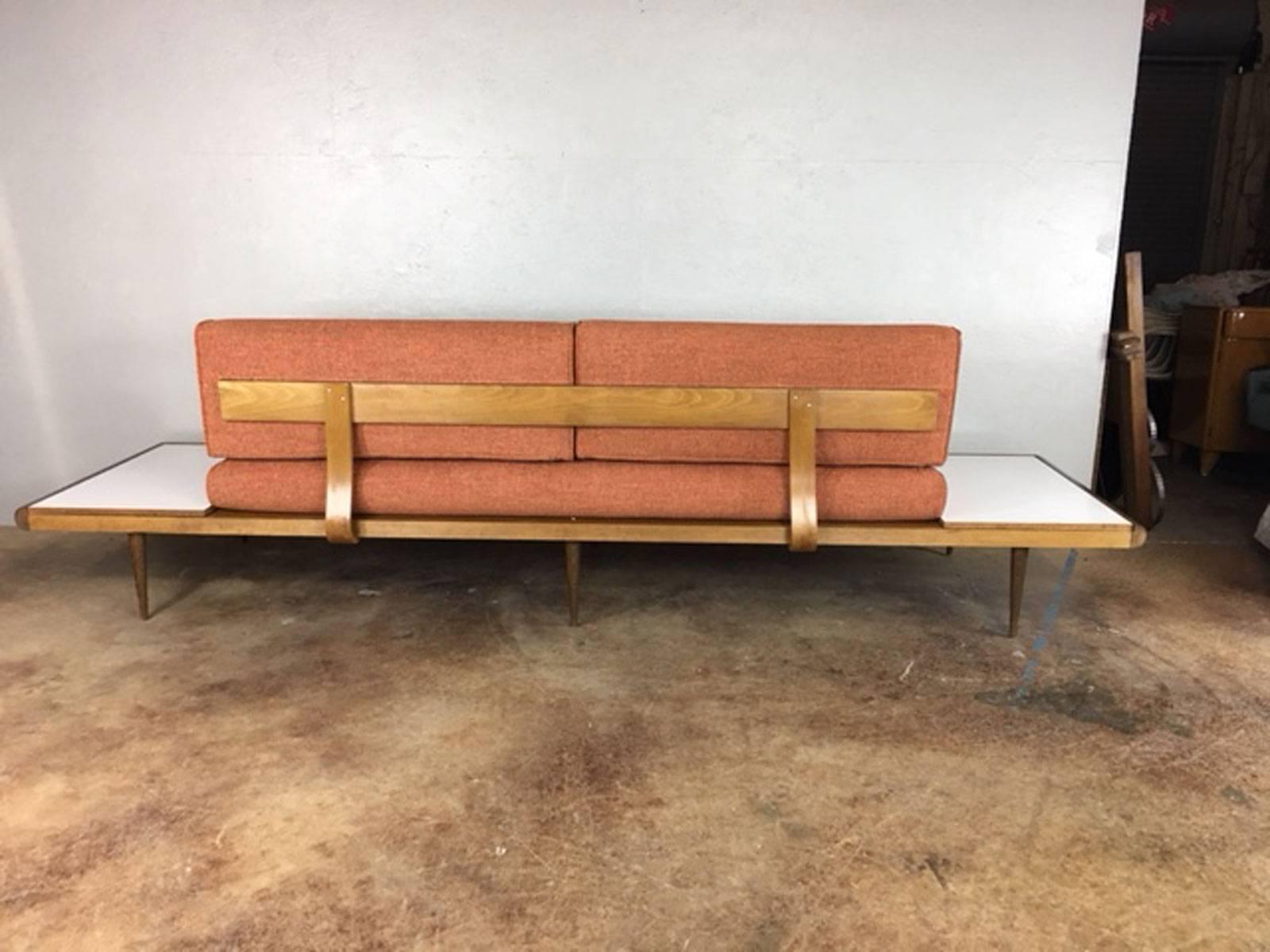 Sharp Adrain Pearsall sofa or daybed with built in white Formica and walnut Formica reversible side tables. Newly reupholstered in a stunning California Urban Collection fabric. 

Measures: Seat height is 17 inches.