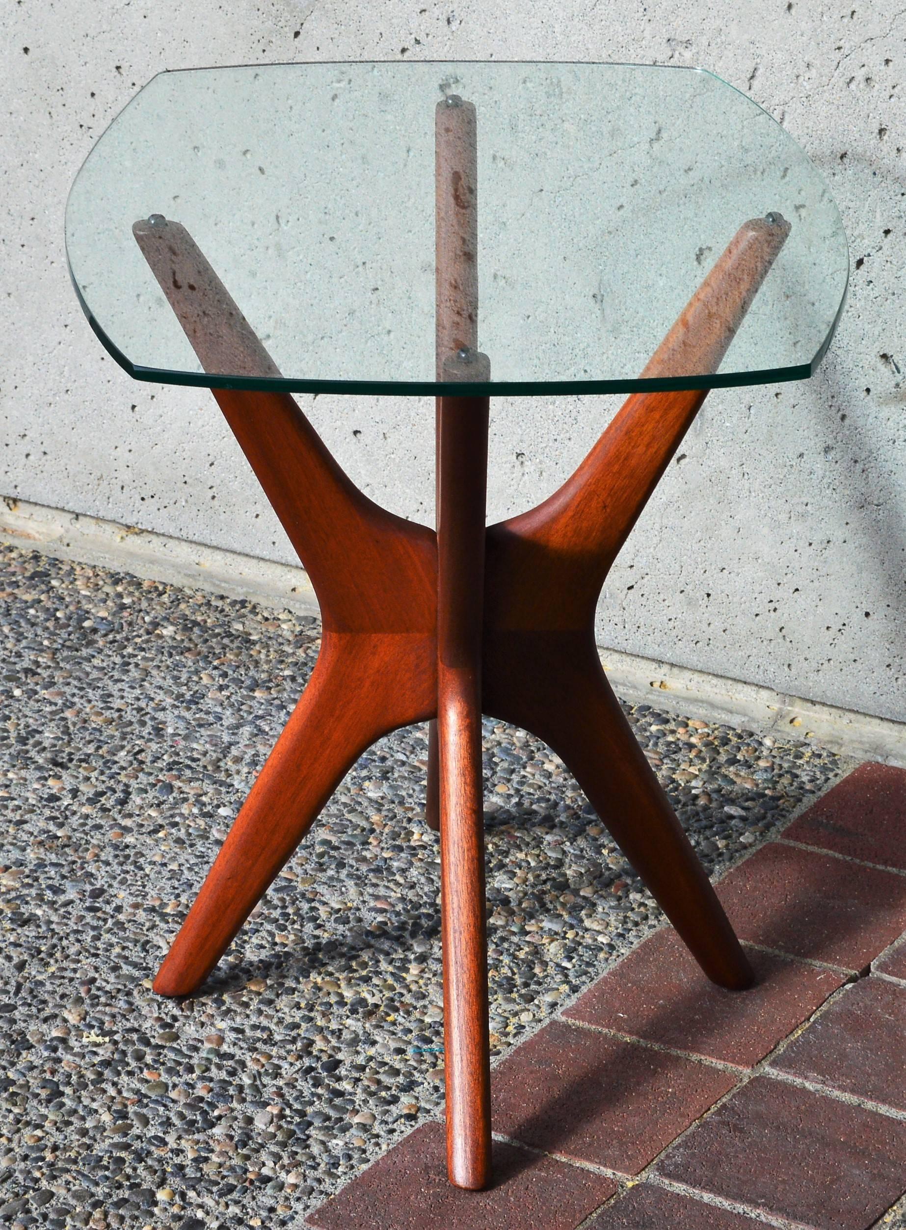 This fabulous iconic Mid-Century Modern solid walnut base side table, reminiscent of childhood Jacks, has an organic shaped curved glass top and the most dramatic lines. Designed by Adrian Pearsall in the 1960s, the base has been completely restored