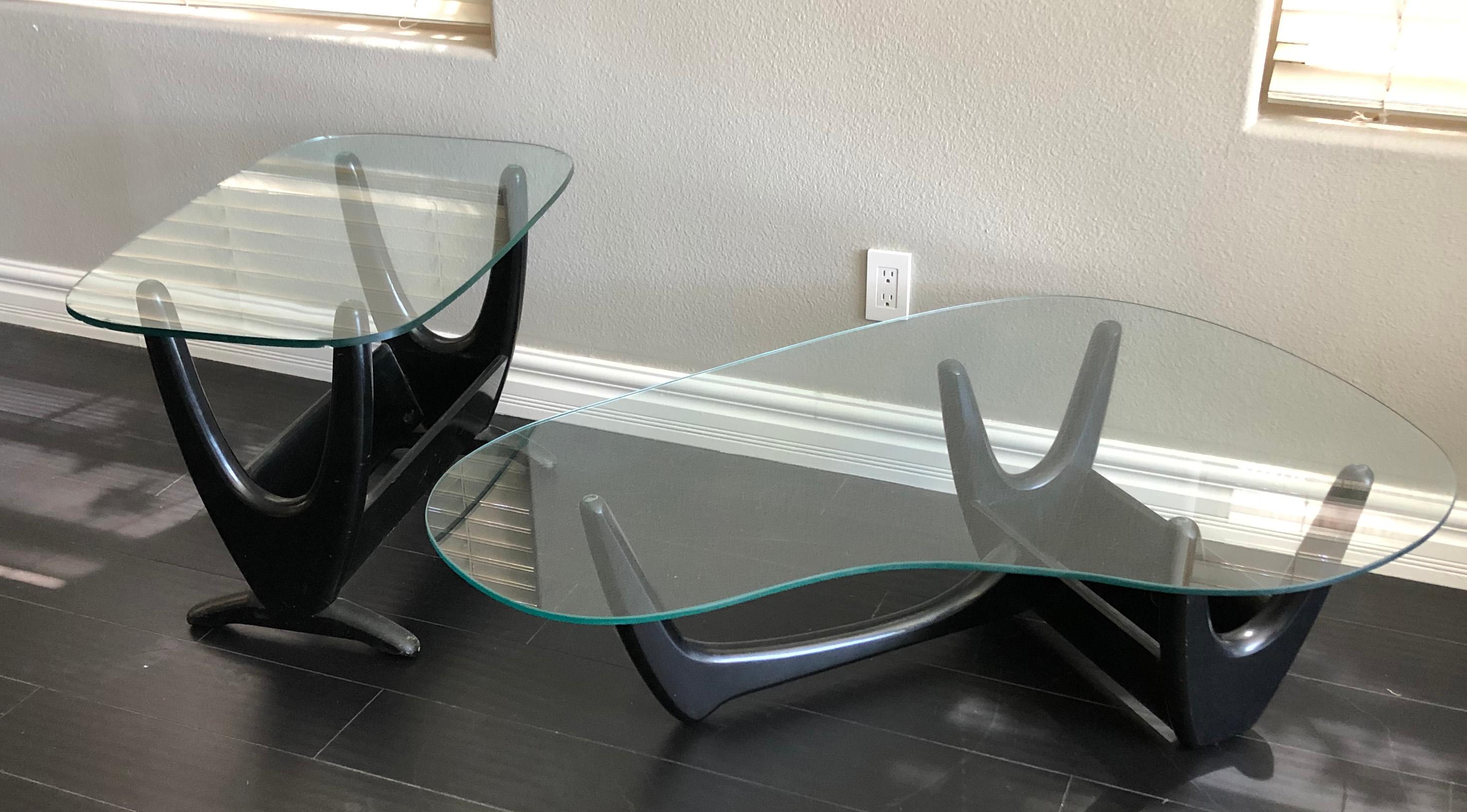 Available right now we have this gorgeous ebonized Pearsall style coffee table and matching side table. These tables are indeed from the 1960s and feature not only a sleek biomorphic shape, they also have their original custom planters that fit