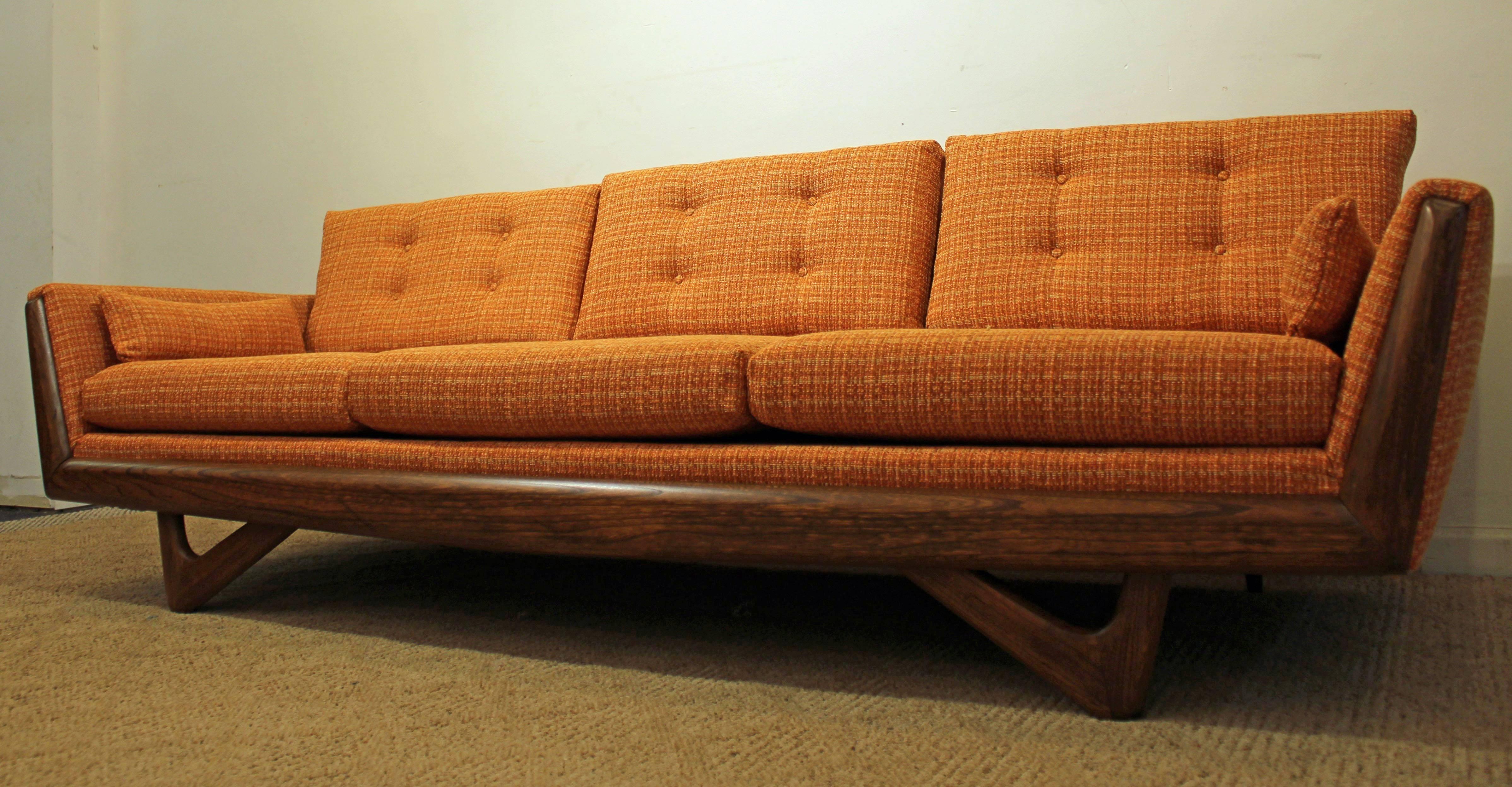 Offered is a gondola sofa similar to the style of Adrian Pearsall. It has been completely restored with new upholstery, cushions, and refinished walnut base.