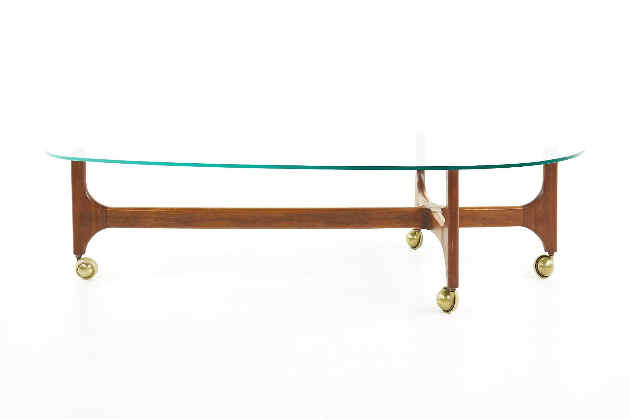Adrian Pearsall style mid century walnut and brass biomorphic coffee table

The table measures: 60.5 wide x 28.25 deep x 15.5 inches high 

All pieces of furniture can be had in what we call restored vintage condition. That means the piece is