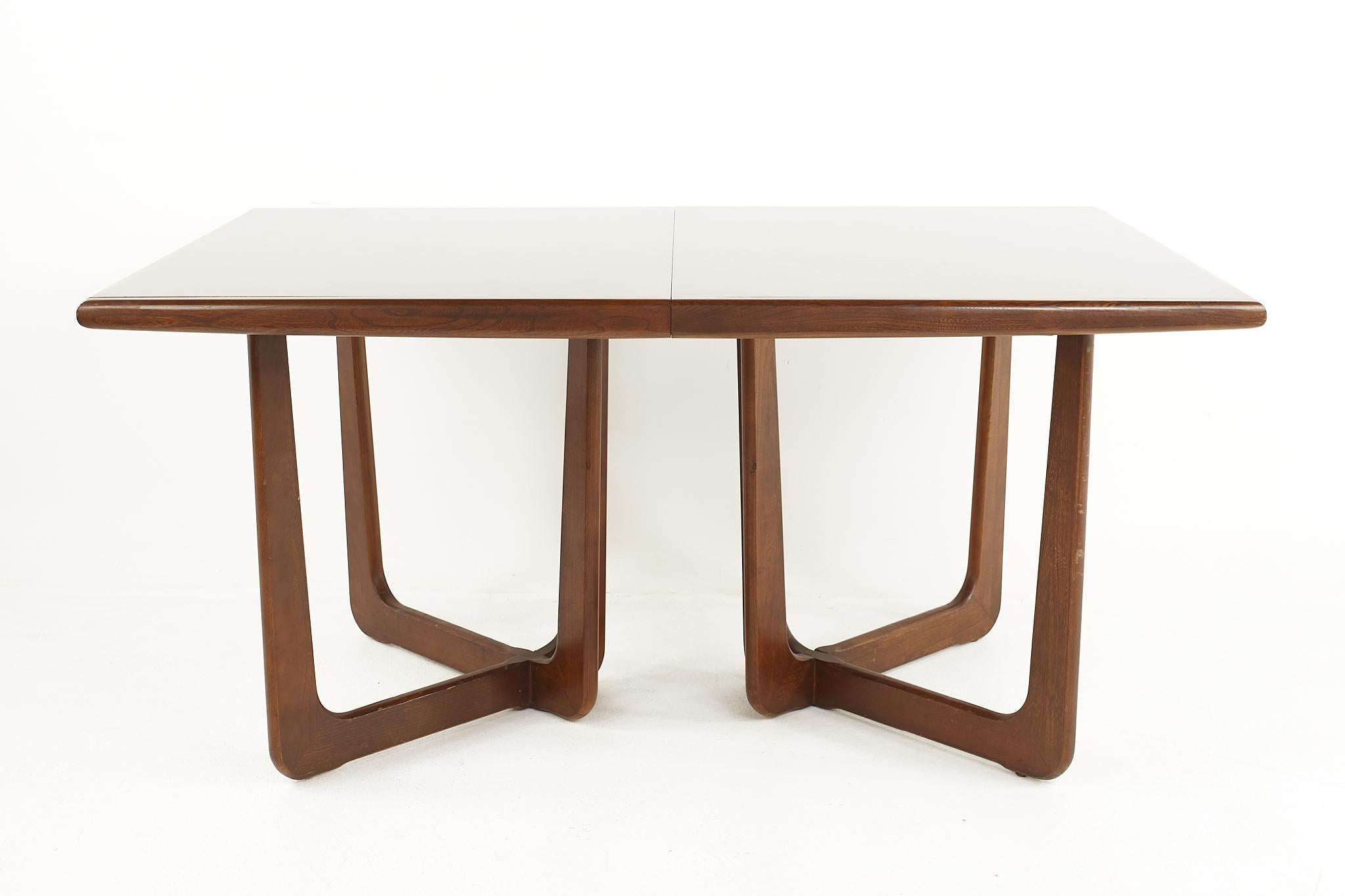 Adrian Pearsall style mid century walnut dining table

The table measures: 62 wide x 42 deep x 29.25 inches high, with a chair clearance of 27 inches; the leaf is 12 inches wide, making a maximum table width of 74 inches when the leaf is used