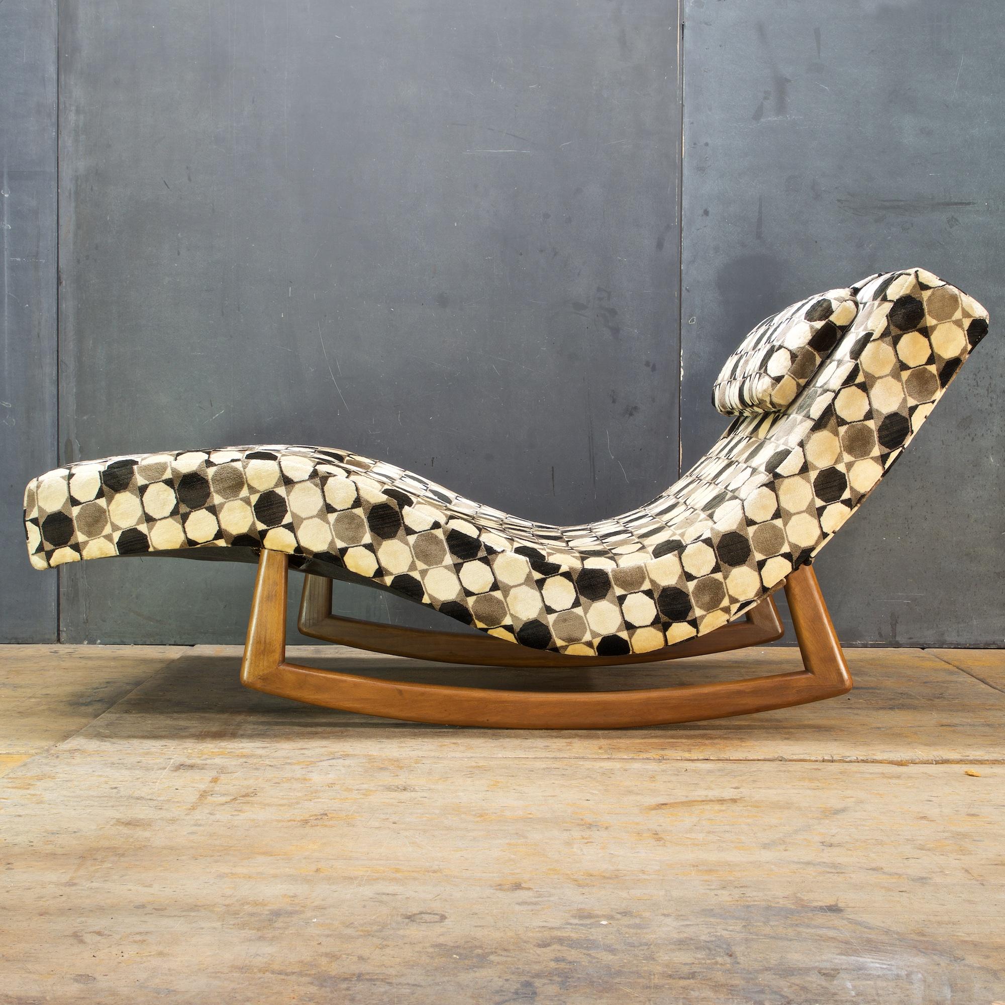 Amazing walnut wave rocking lounge, in loud 1980s upholstery.