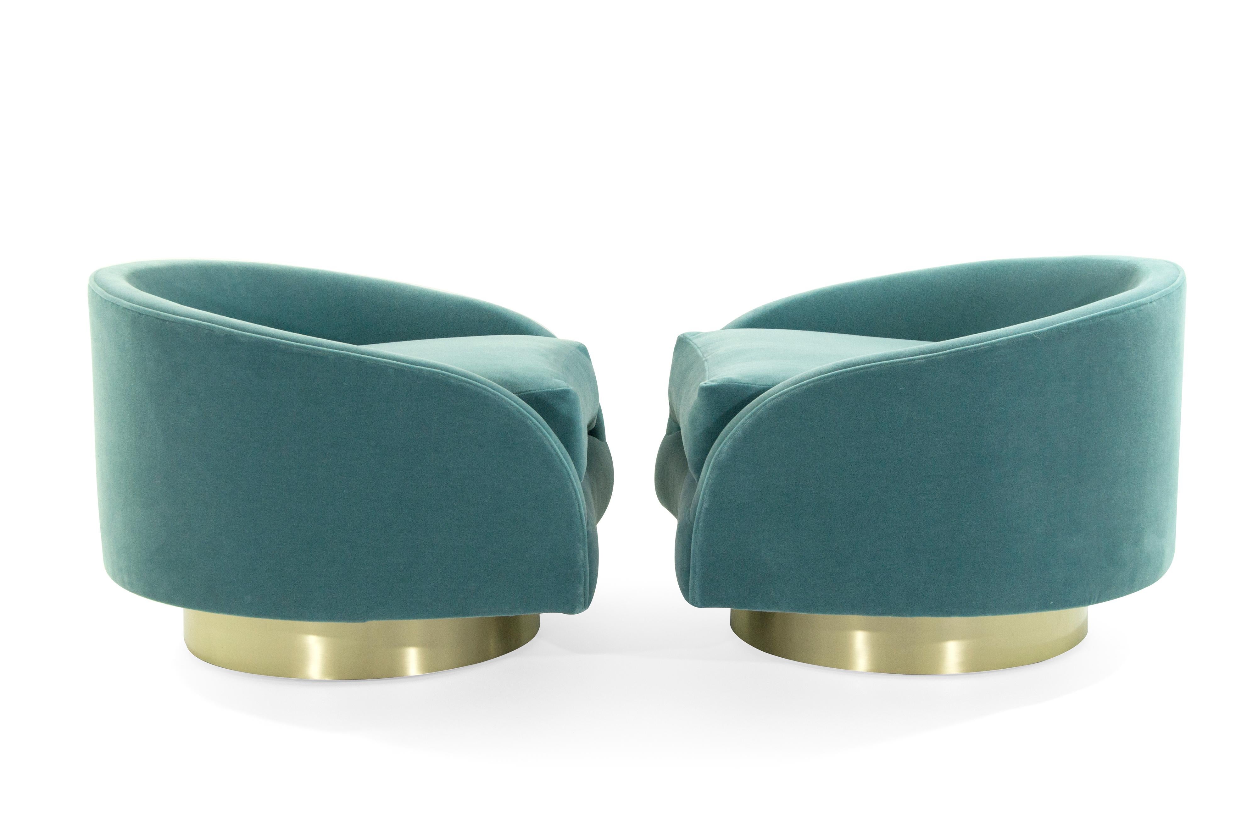 Extremely comfortable set of low-wide profile swivel lounges designed by Adrian Pearsall for Craft Associates, circa 1950s.

Newly upholstered in light blue mohair, new polished brass bases.