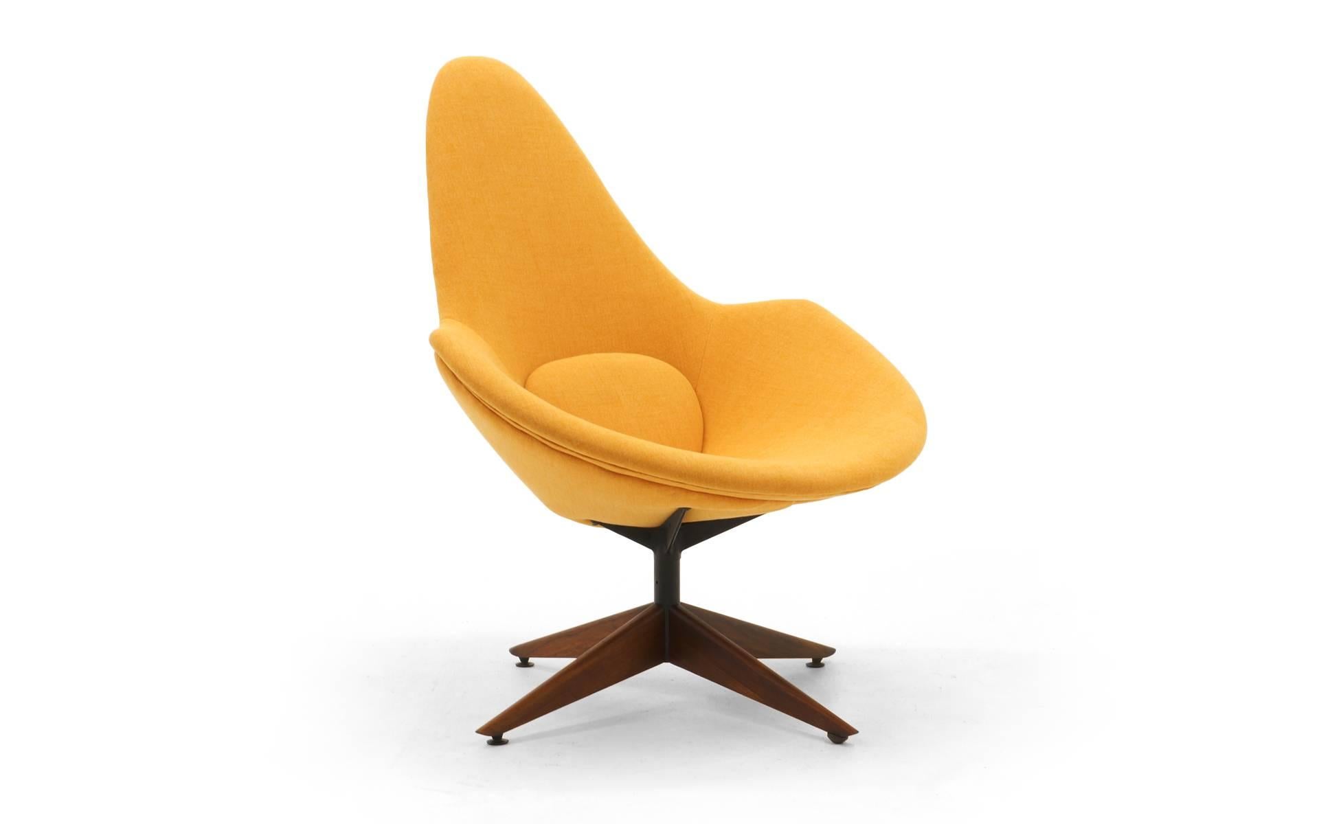 One of the best Adrian Peasall designs we have ever seen. This swivel chair has been completely restored from the inside out. Very comfortable. Mod, organic design. Light peach color Maharam fabric with attached lumbar pillow which is part of the