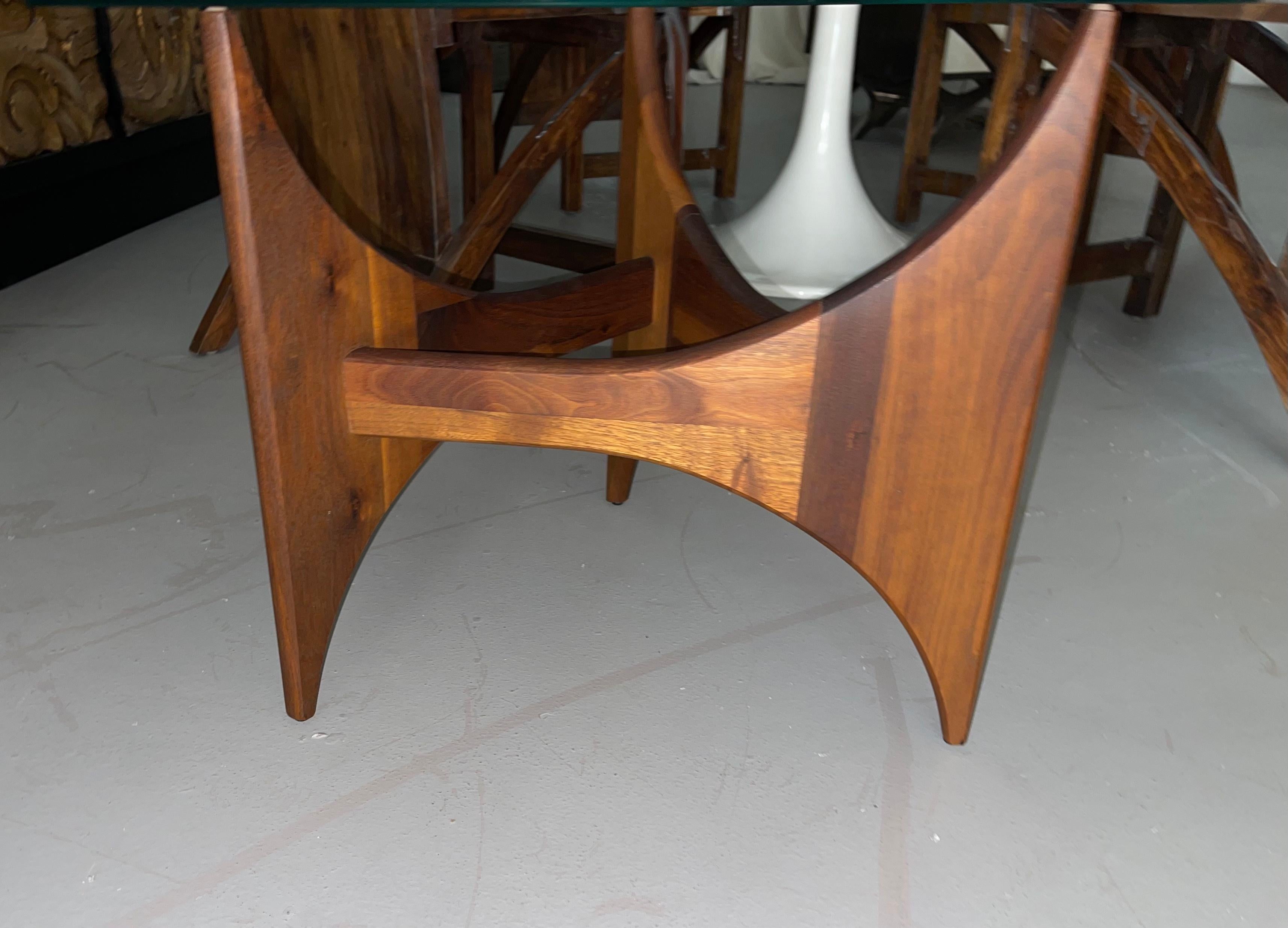 A vintage side table designed by Adrian Pearsall. Walnut base, triangular glass top. Good vintage condition, some minor marks to the glass top from age and use.