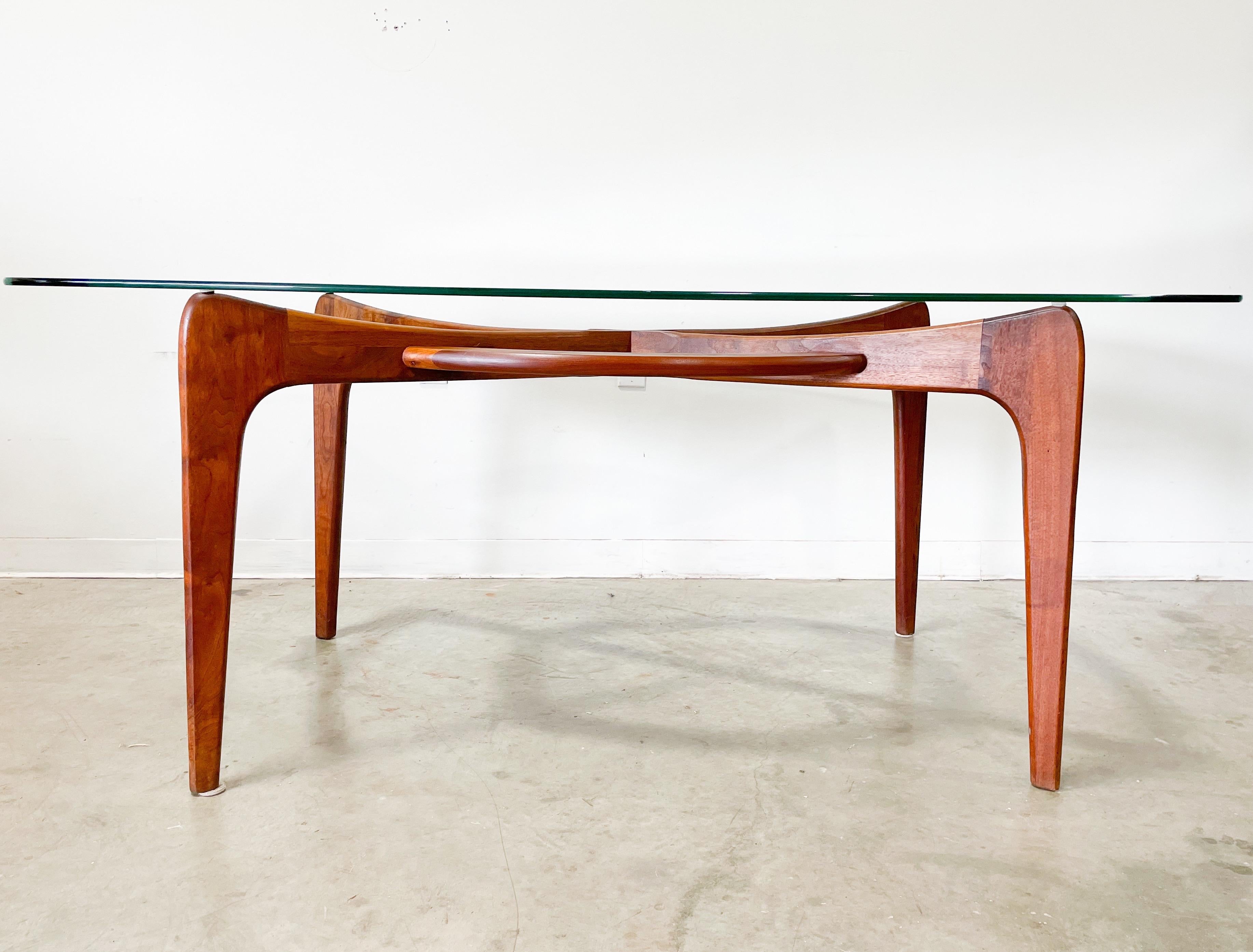 Vintage Mid-Century Modern dining table designed by Adrian Pearsall for his company Craft Associates in the 1960s. Beautifully sculpted solid walnut frame and distinctive boat shaped top. Frame has gorgeous wood grain and is very sturdy. Top is in