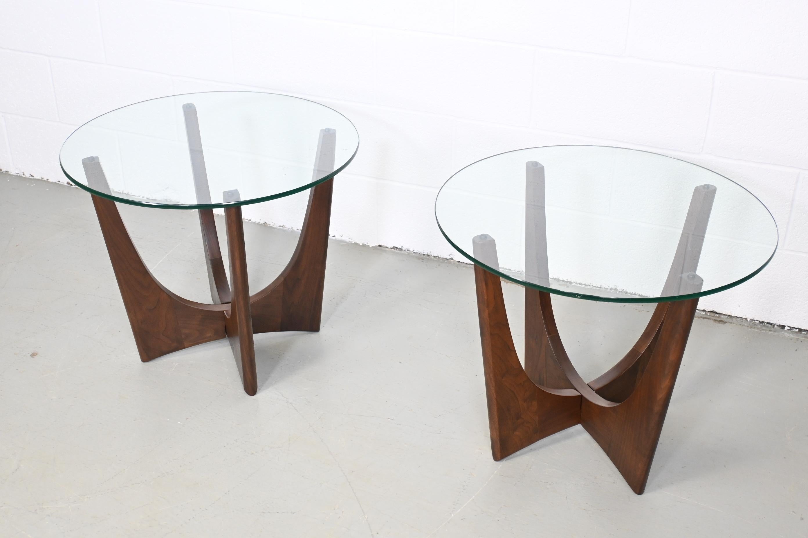 Adrian Pearsall style walnut base with glass top side or end tables.

Unmarked, USA, 1960s.

Measures: 24 wide x 24 deep x 20.5 high.

A pair of Mid-Century Modern sculpted walnut base with round glass top side or end tables.

Bases have been