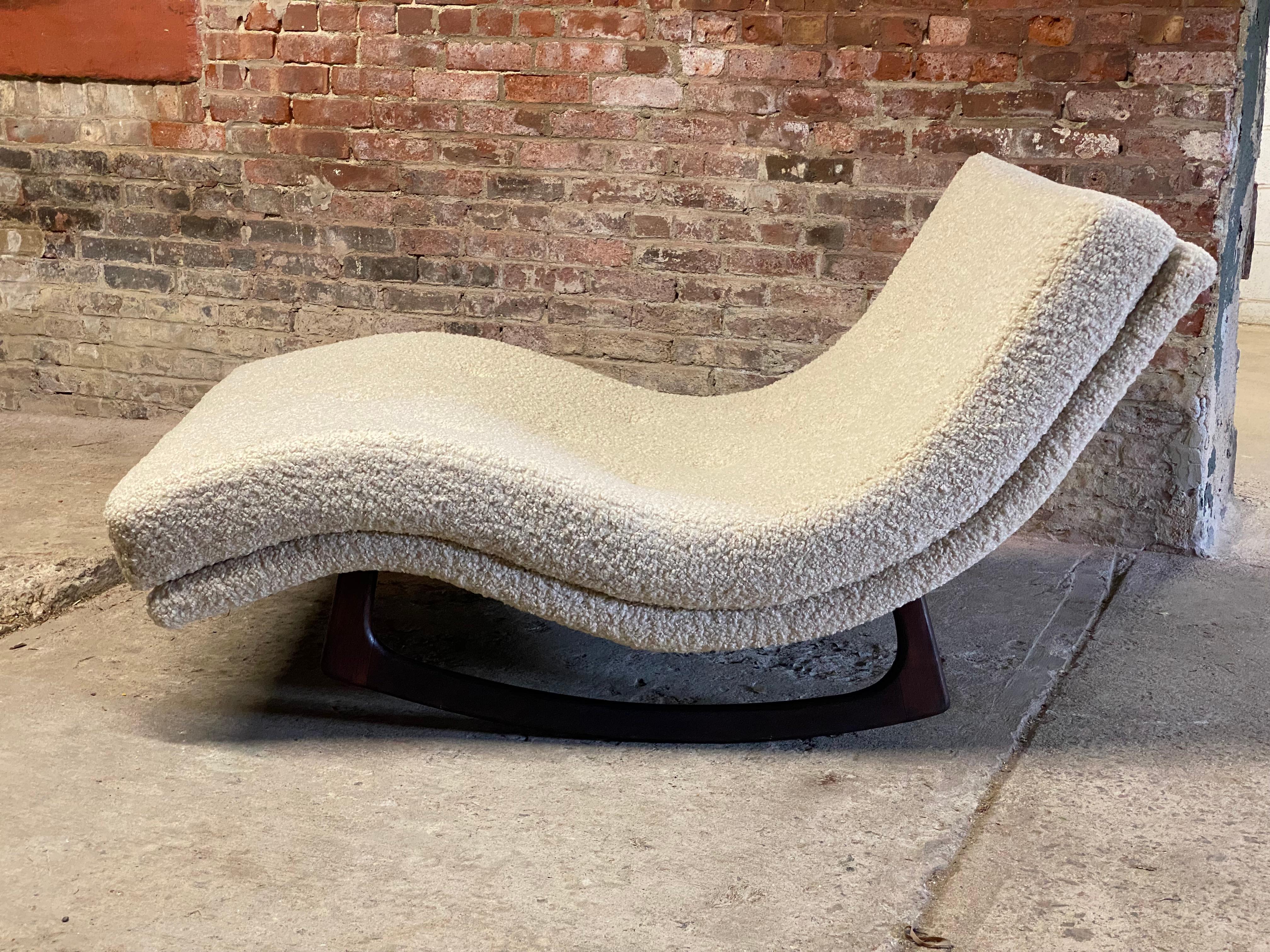 Waive chaise walnut and boucle rocker. The ultimate lounging chair for reading, a disco nap or watching a movie. Circa 1960. Solid walnut base and reupholstered in a cozy white boucle and all new foam. Structurally sound and sturdy construction.