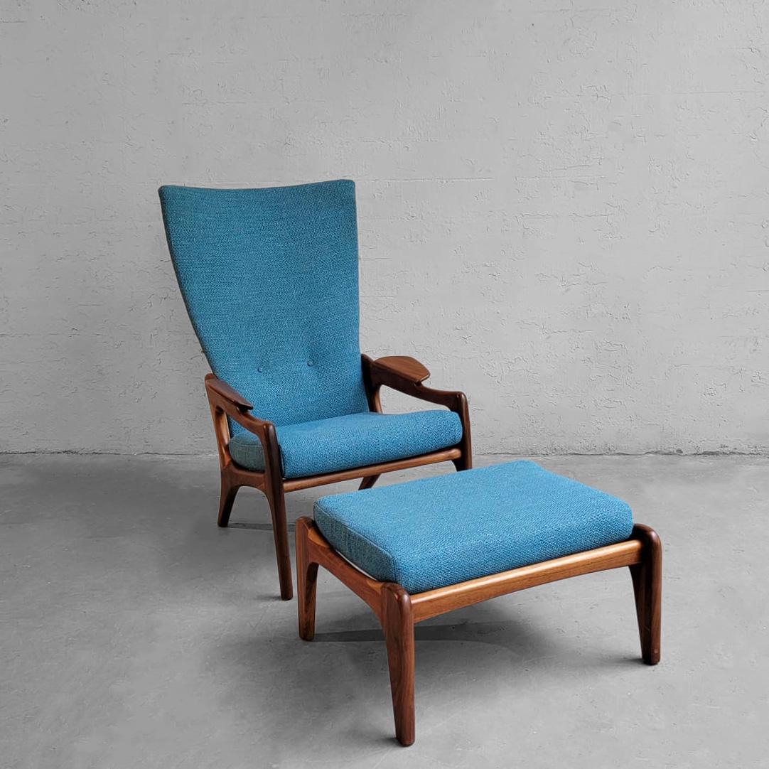 Mid-Century Modern take on a wingback chair designed by Adrian Pearsall for Craft Associates features a high curved back with sculptural walnut frame with matching ottoman measuring 25.5 w x 21.5 d x 15 ht inches.