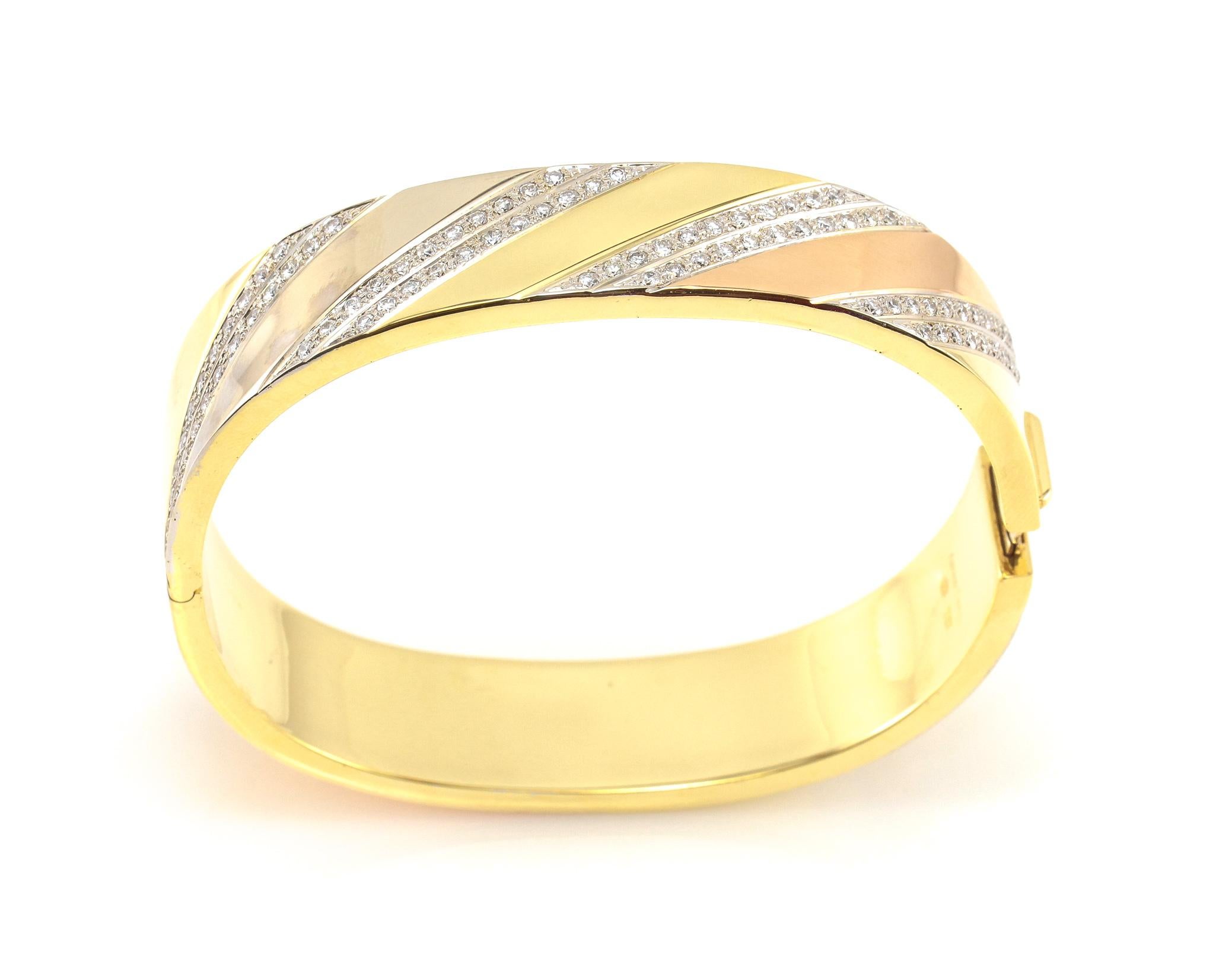 This is a stunning 18K Yellow, White, and Rose Gold Adriano Chimento Diamond Bangle Bracelet. Adriano Chimento is a jeweler who's designs represent the traditions of fine Italian craftmanship and precious metalwork.  Beautifully set in diagonal