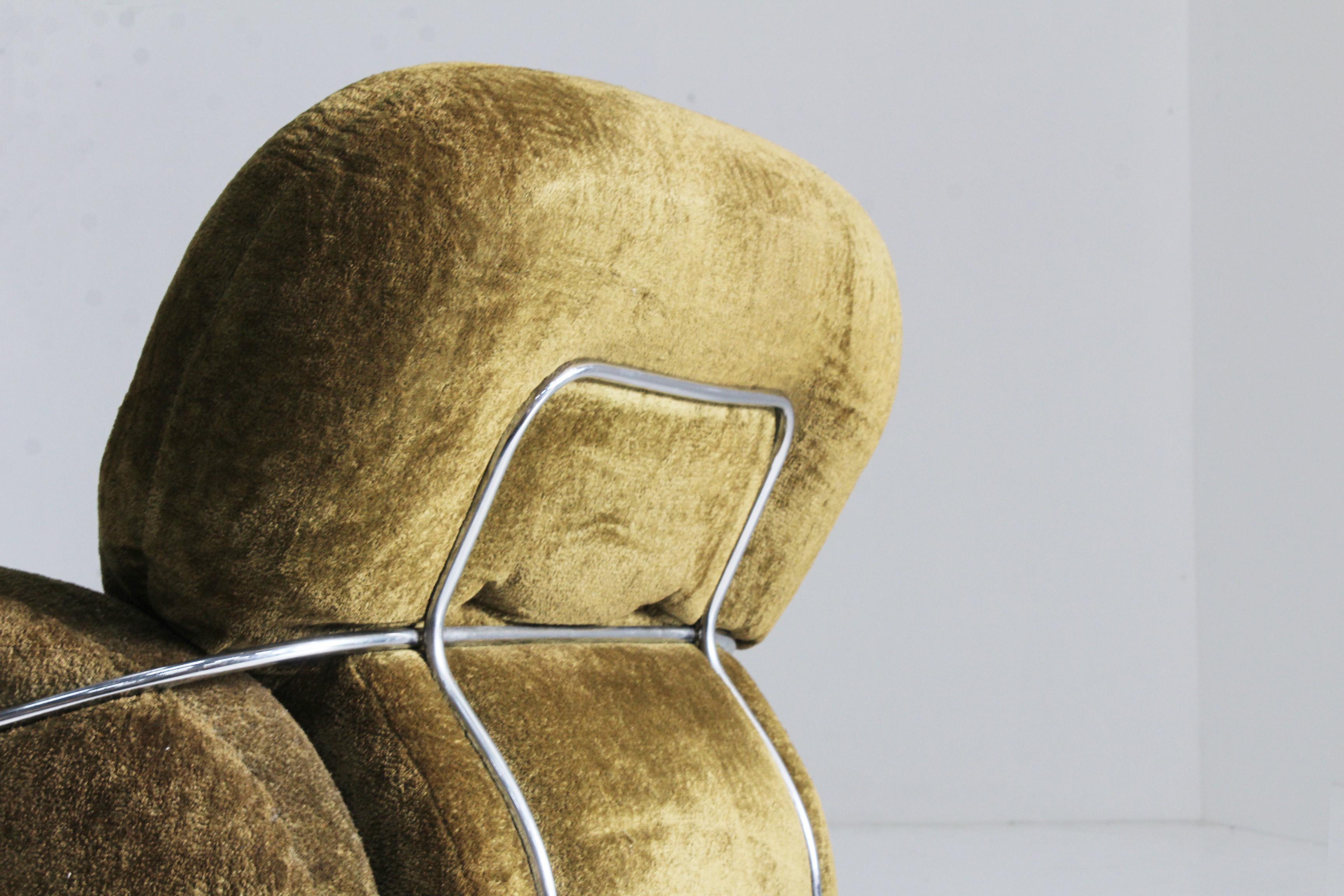 Green velvet Okay armchair designed by Italian designer Adriano Piazzesi in the 1970s. This comfy chair is in a good condition with minor traces of use. This chair has a green velvet fabric with a chromed metal structure.