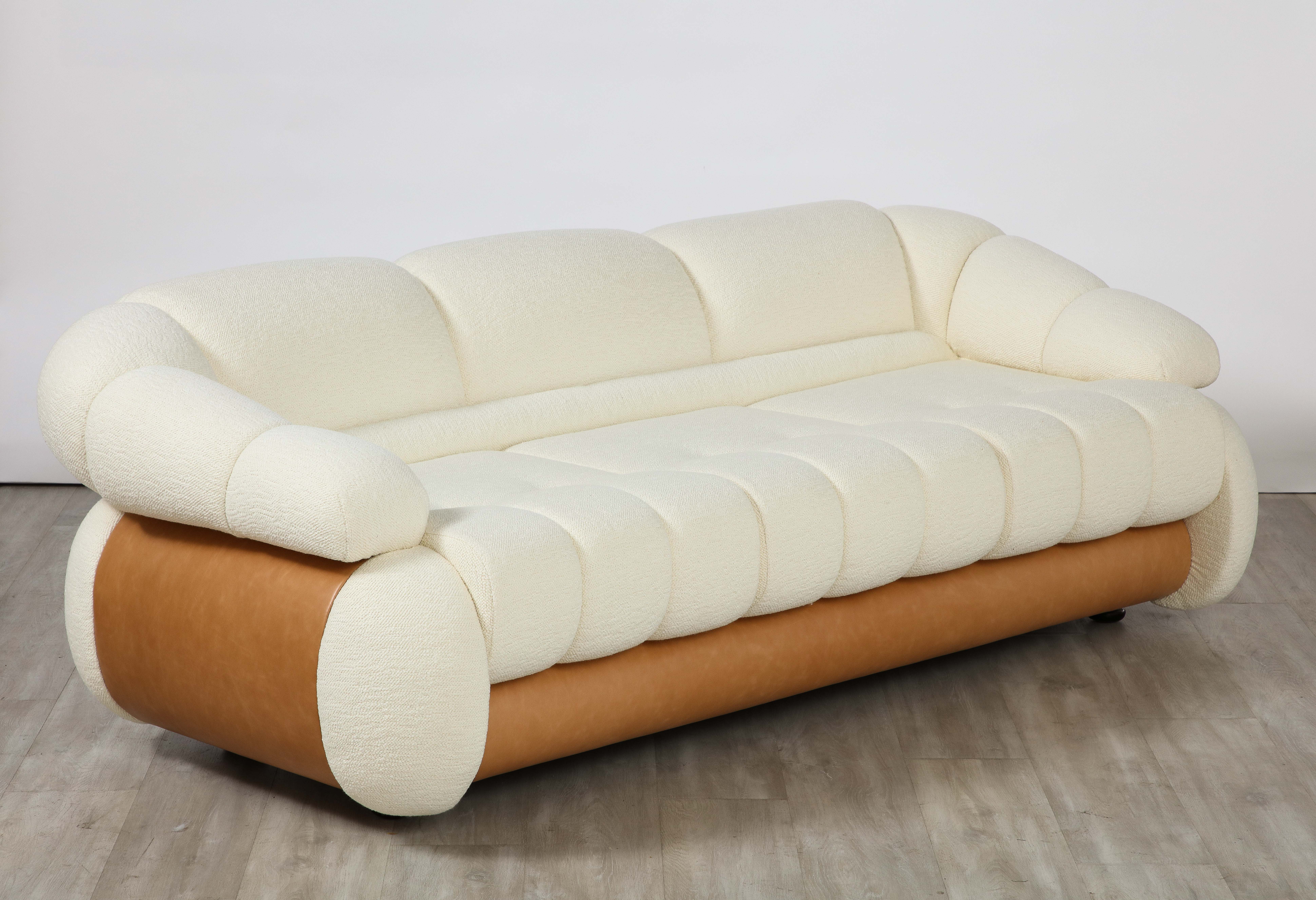 Adriano Piazzesi Italian 1970's sofa; the whole with channel and tufted upholstery, the sides and back are curved and covered in a warm brown Italian leather. The sofa is constructed of original solid wood structure and has been completely restored