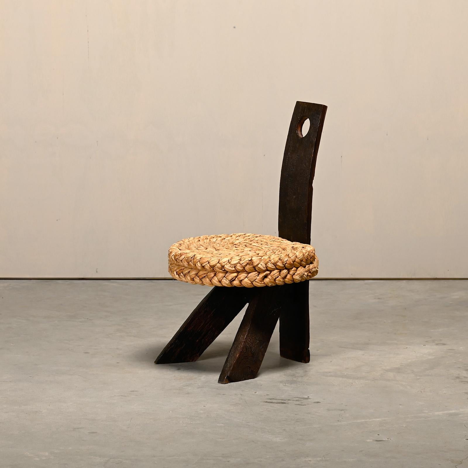 Adrien Audoux and Frida Minnet Brutalist Tripod Fireplace Stool, France, 1950s. Dark stained oak tripod frame with a round straw seat. The wood was originally used for wine barrels, giving the stool a rustic look. The natural texture of the straw