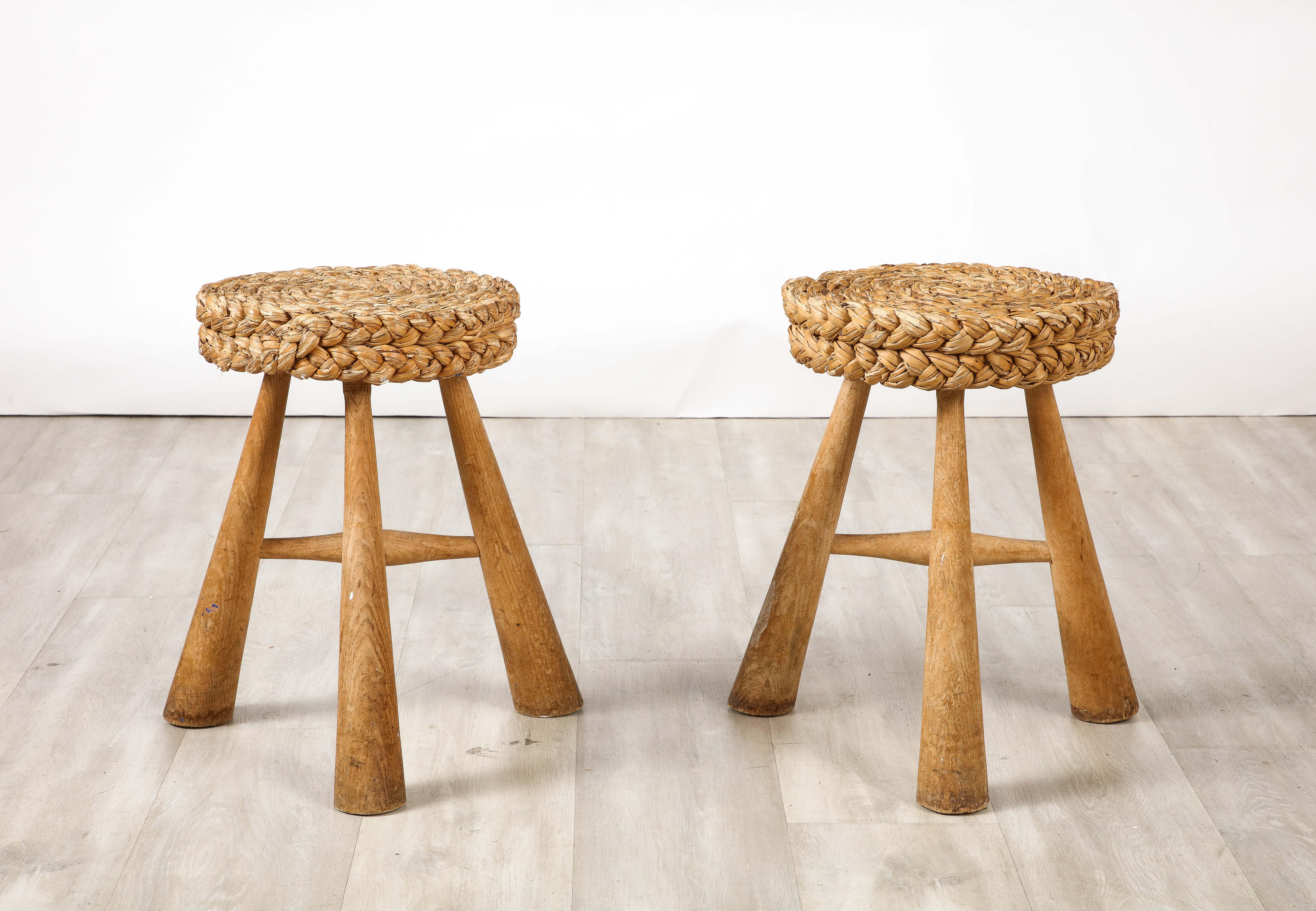 A wonderful pair of stools designed by Adrien Audoux and Frida Minnet with their iconic hand-woven and braided rush circular seats, supported on robust sculpted oak tripod leg bases.  Highly sculptural and iconic suited for any interior style.
by
