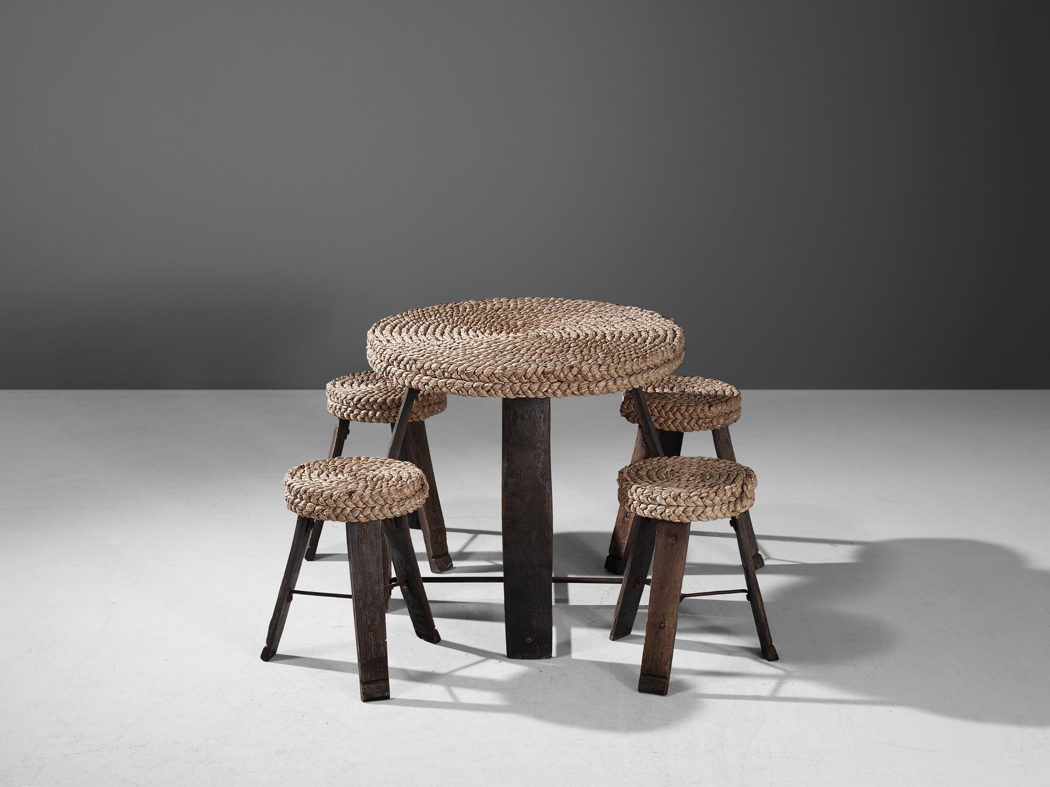 Adrien Audoux and Frida Minet, set of table and four stools, oak, straw, France, 1950s.

This rare set was created by the French designer couple Adrien Audoux and Frida Minet. 

The legs of the table are made of dark oak. The wood was originally