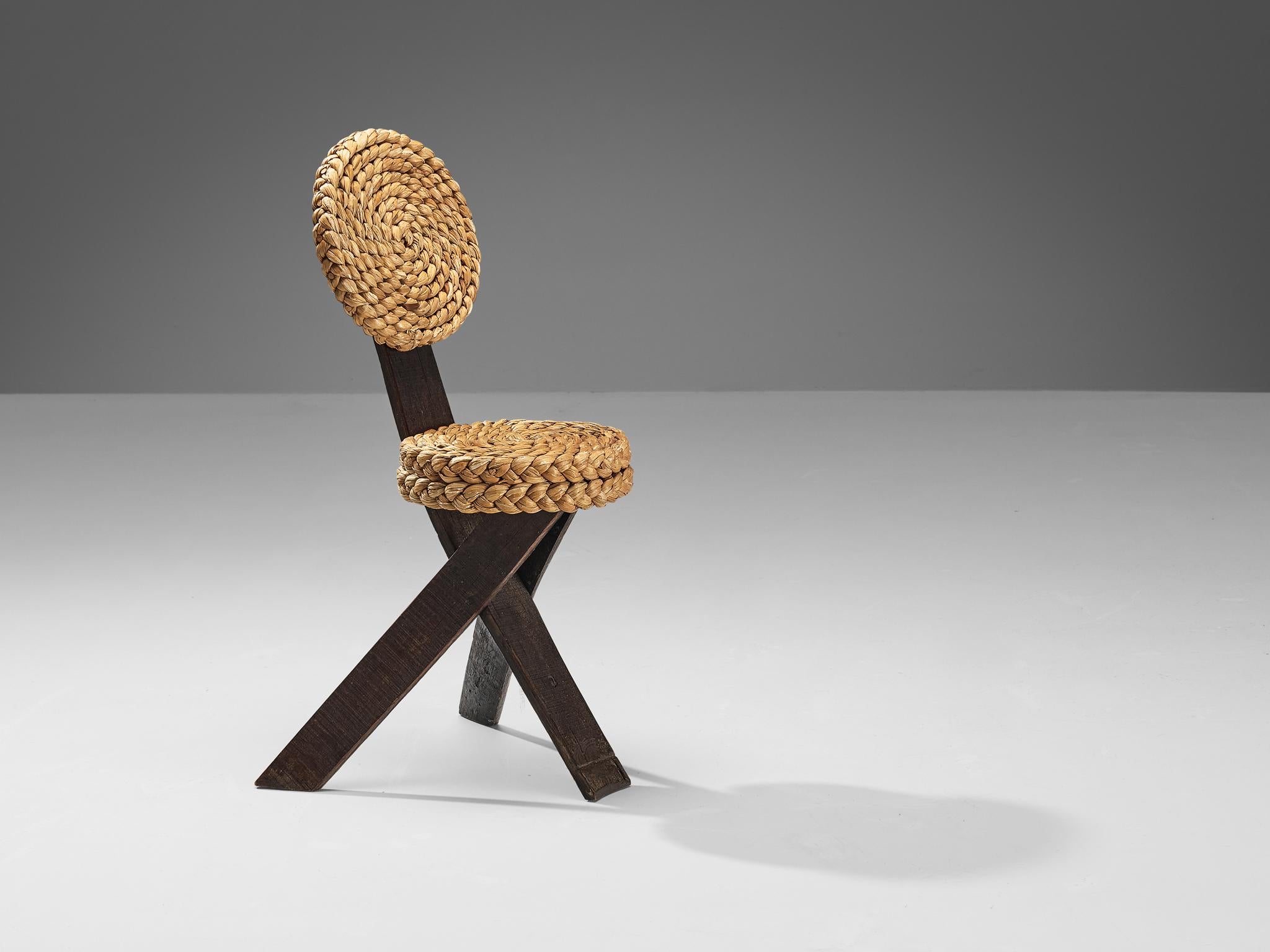 Adrien Audoux and Frida Minet, side chair, oak, straw, iron, France, 1950s

This sculptural side chair was created by the French designer couple Adrien Audoux and Frida Minet. The three flat legs are made of dark oak. One leg runs upwards and ends