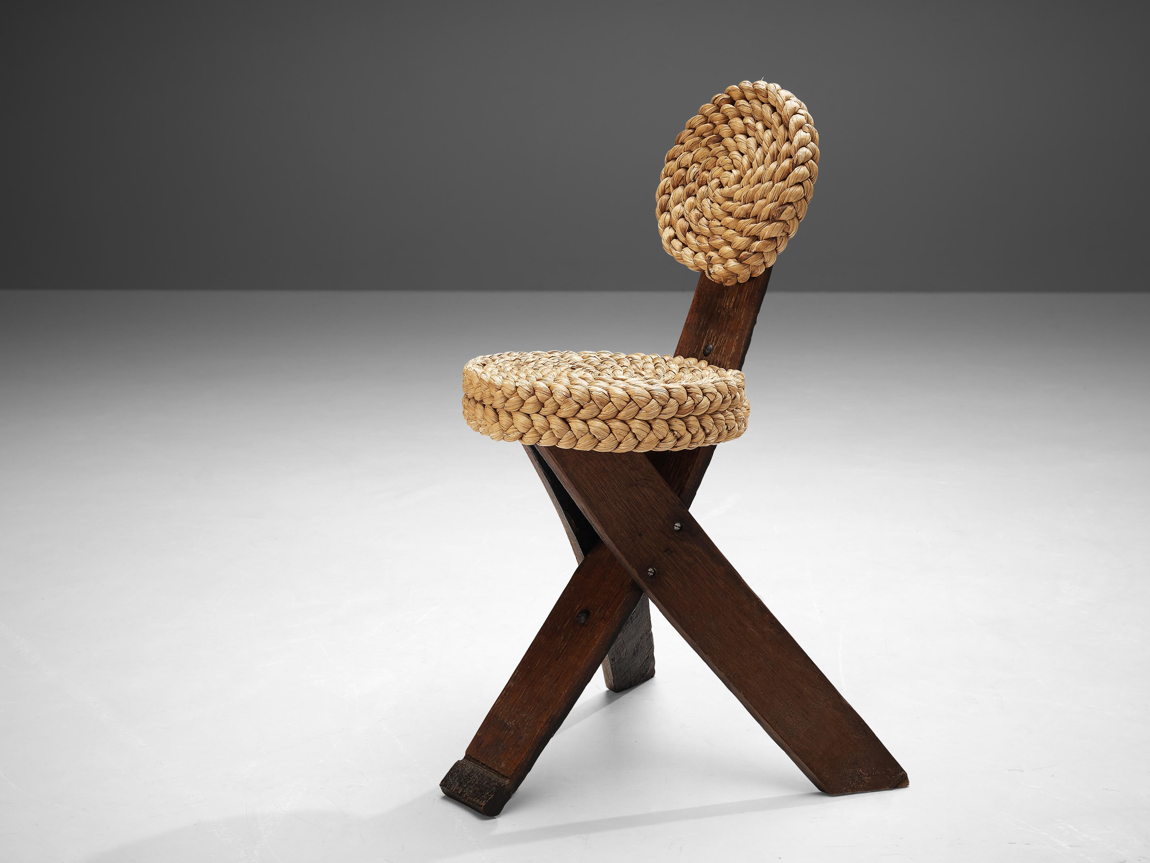 Adrien Audoux and Frida Minet, side chair, oak, straw, France, 1950s

This rare, sculptural side chair was created by the French designer couple Adrien Audoux and Frida Minet. The three flat legs are made of dark oak. One leg runs upwards and ends