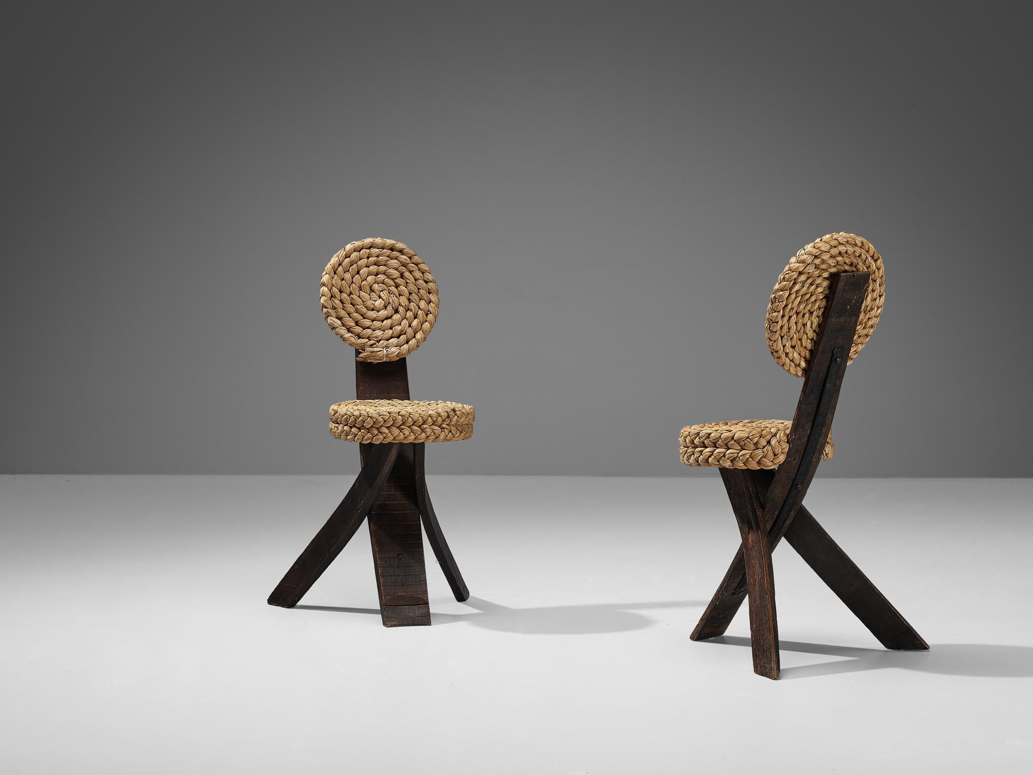 Adrien Audoux and Frida Minet, side chairs, oak, straw, iron, France, 1950s

This sculptural side chair was created by the French designer couple Adrien Audoux and Frida Minet. The three flat legs are made of dark oak. One leg runs upwards and ends