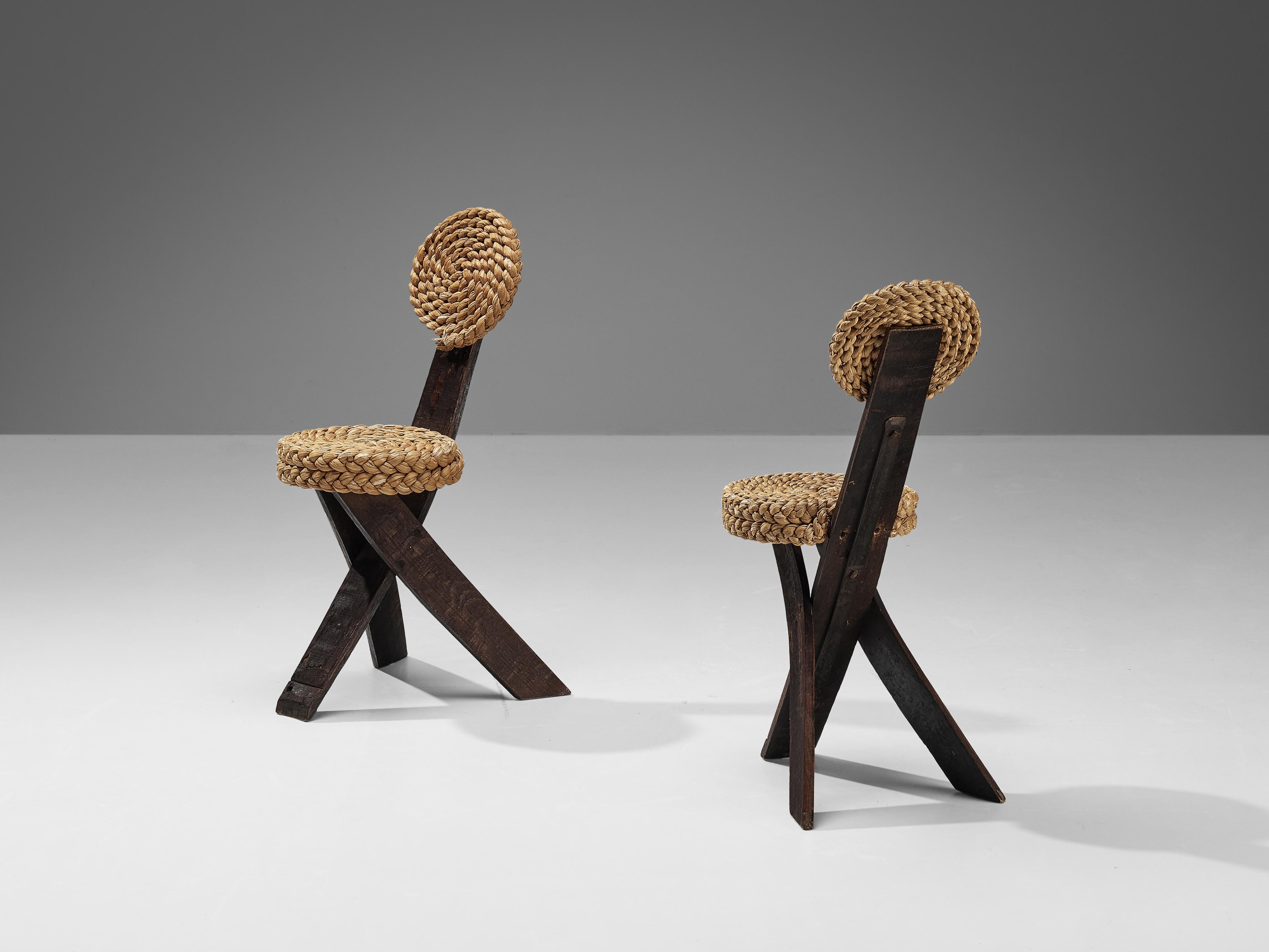 Adrien Audoux and Frida Minet, side chairs, oak, straw, iron, France, 1950s

This sculptural side chair was created by the French designer couple Adrien Audoux and Frida Minet. The three flat legs are made of dark oak. One leg runs upwards and ends