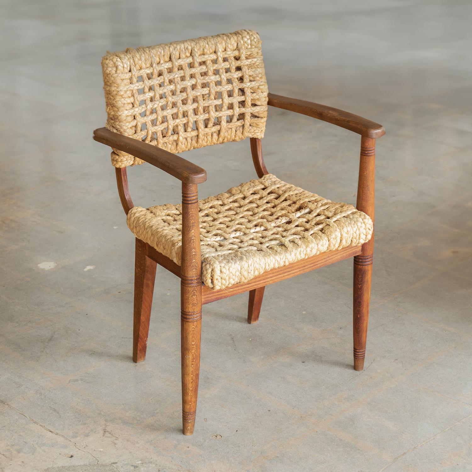 Vintage Adrien Audoux & Frida Minet lounge chair from France, 1950s. All original wood with nice patina and age. Original rope seat has one newly replaced cord. Beautiful carved detailing on arms. Stunning and iconic piece.