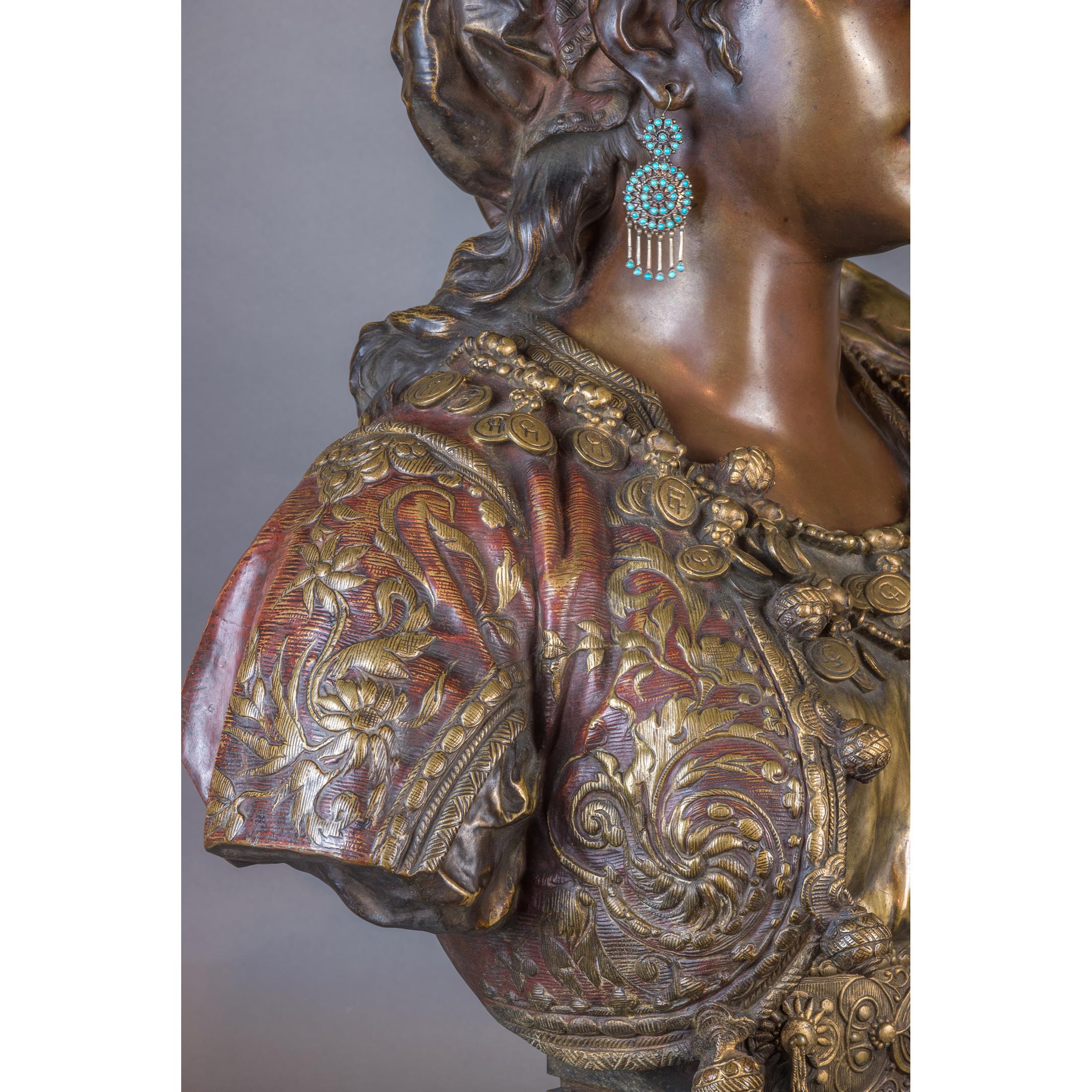 A Fine Quality Polychrome-Patinated Bronze Bust of an Orientalist Princess. 
The Princess wears a luxurious gold and silver brocade vest, with patinas that skillfully imitate gold and silver threads. Adrien-Etienne Gaudez's mixed media approach