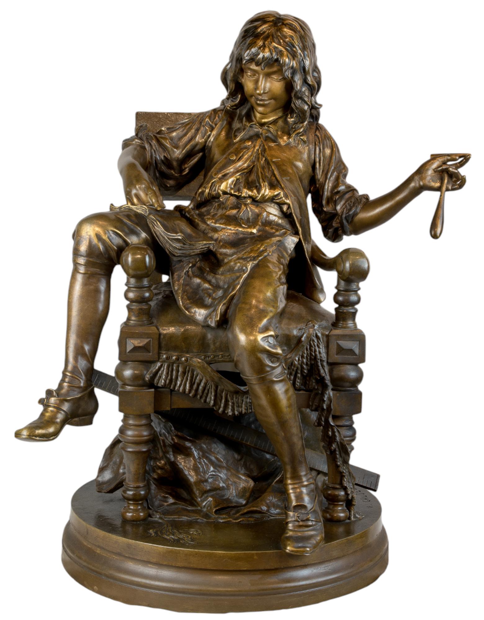 This delightful cast bronze statue The Upholster’s Apprentice showcases a young boy, reclined and reading in the chair he is presumably working on. The boy should be busy at work, using the hammer that dangles from his left hand, the luscious roll