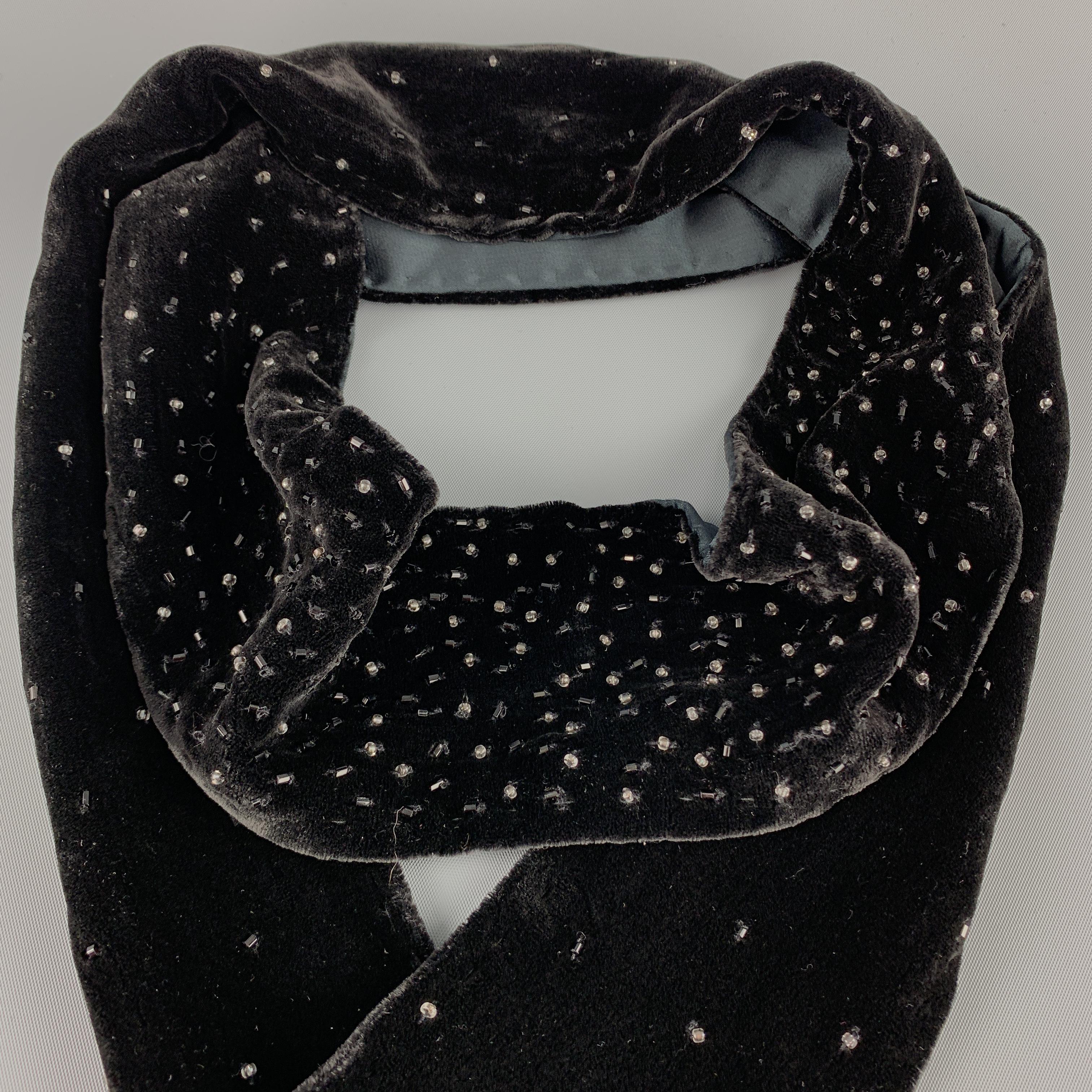 ADRIENNE LANDAU neck scarf comes in beaded silk velvet with satin liner and three inch beaded fringe trim. 

New with Tags.

69 x 3 in.