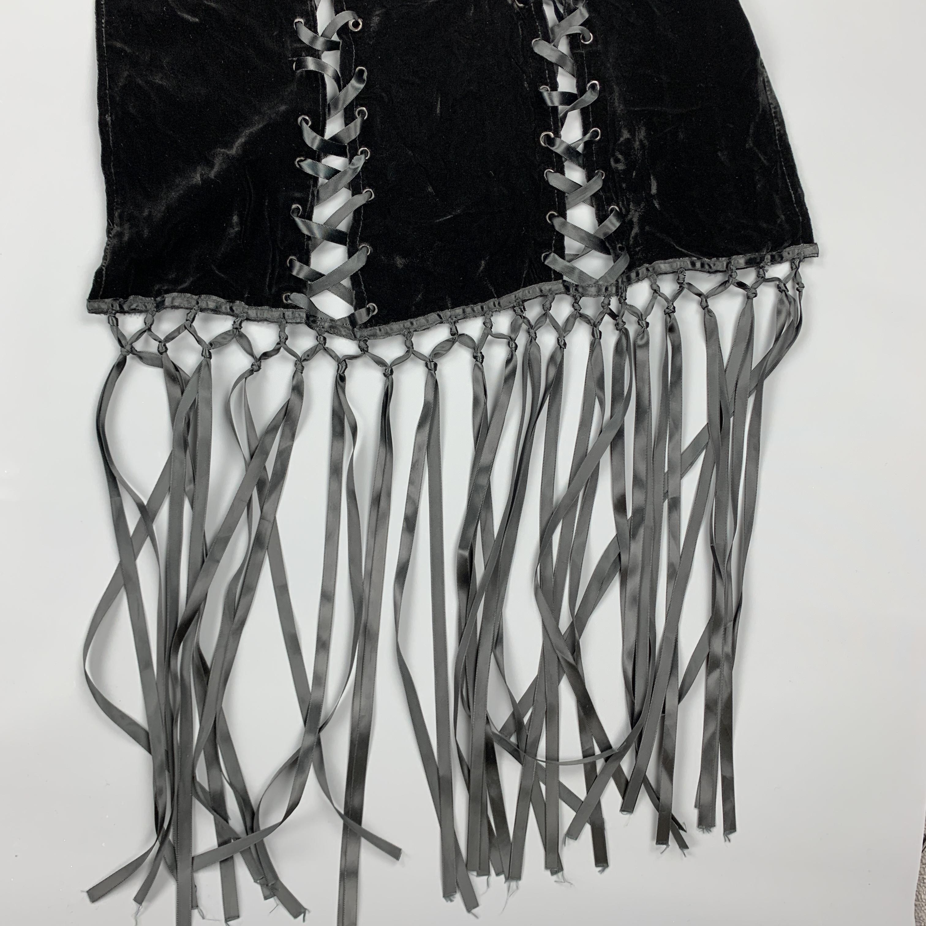 ADRIENNE LANDAU scarf comes in black velvet with a ribbon laced cutout grommet panels and long seventeen inch woven fringe trim. 

Good Pre-Owned Condition.

Length: 84 - 108 in.
Width: 21 in.