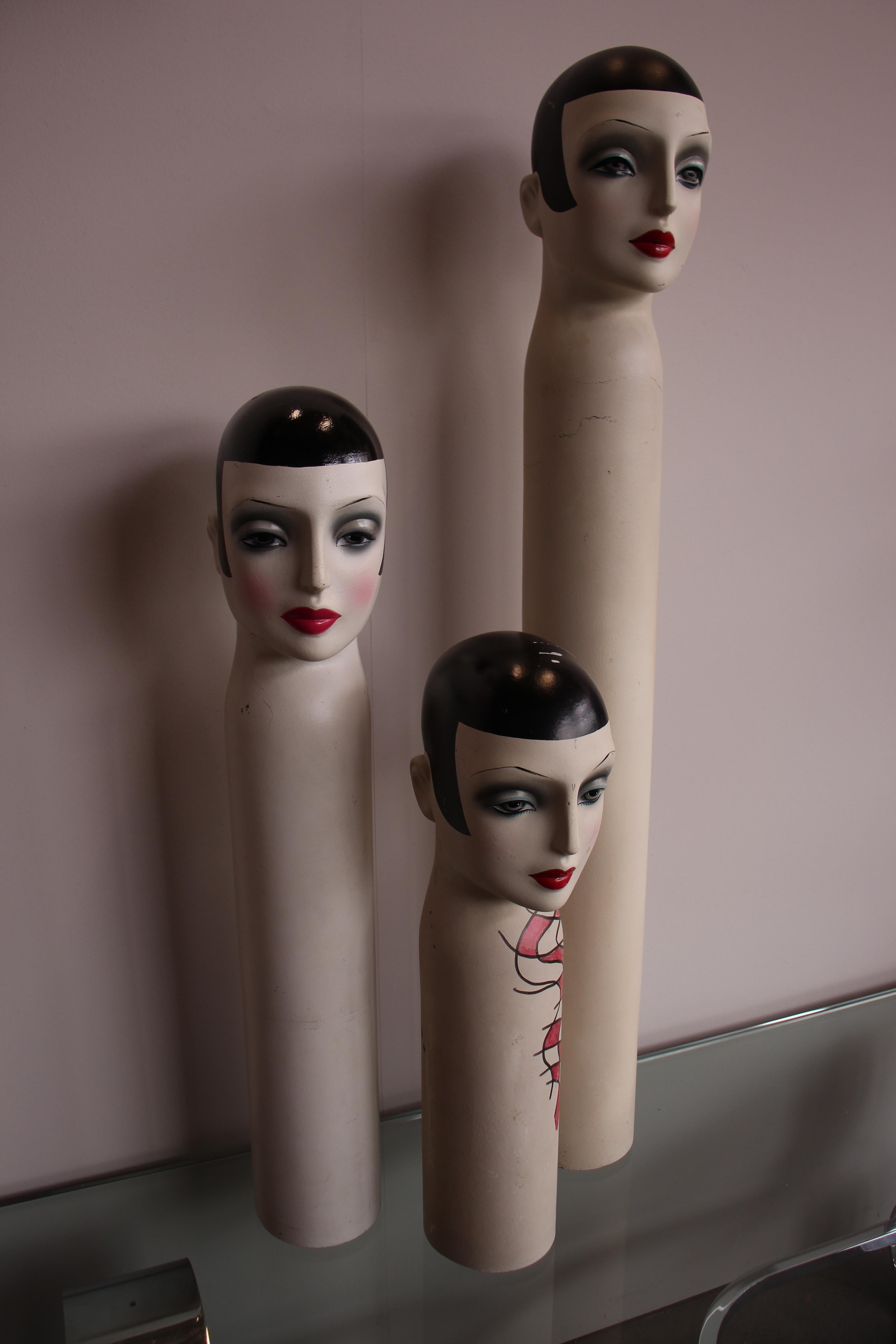 Mannequins for hats and scarves from the 1950s. The figures were family owned and were repainted in the 1980s. The dolls are reminiscent of the women paintings by Tamara de Lempikca and the glamorous Art Deco Look of the 1920s.
 