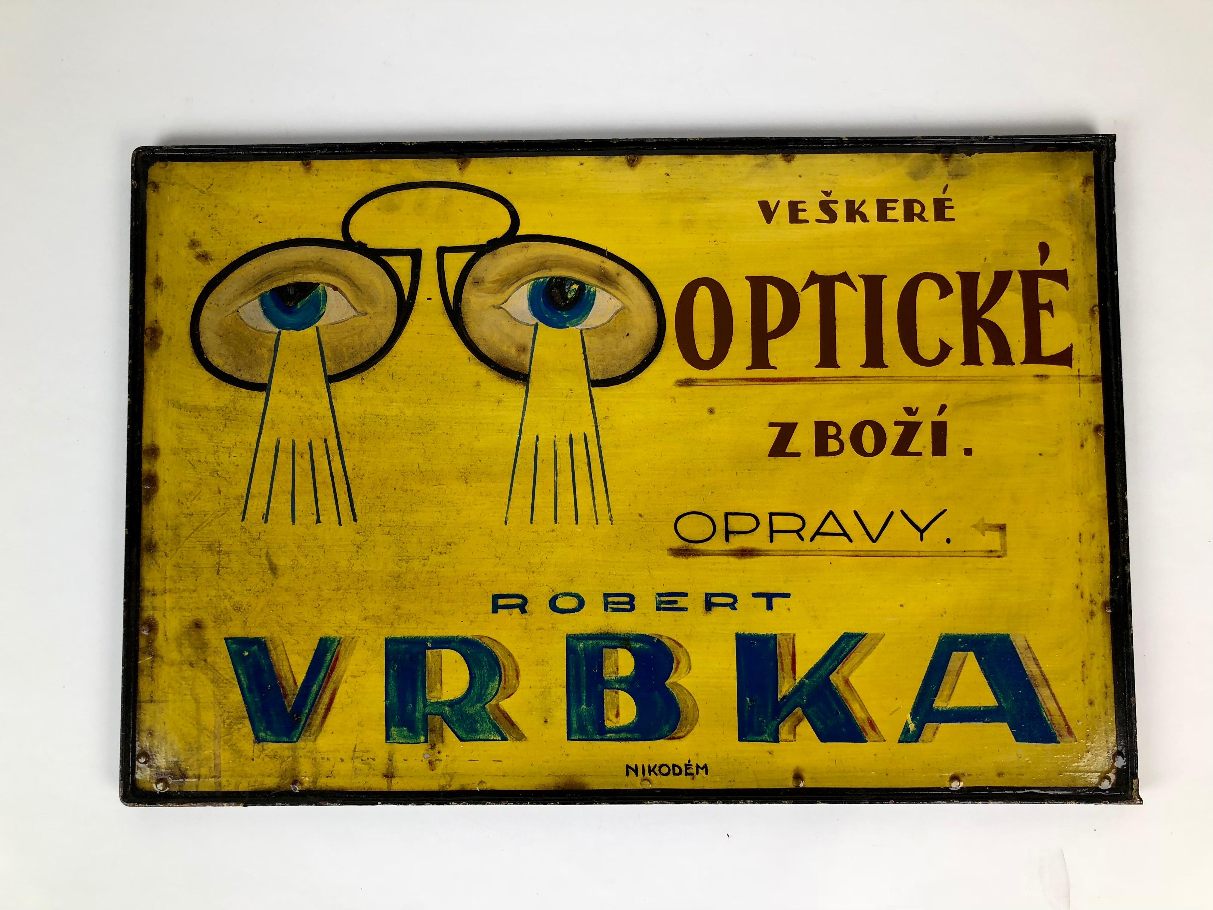 Hand painted metal advertising sign for an optician.
The shield was attached to the facade on an optician shop and is painted with the same motive on both sides.
Signed from the sign painters: 