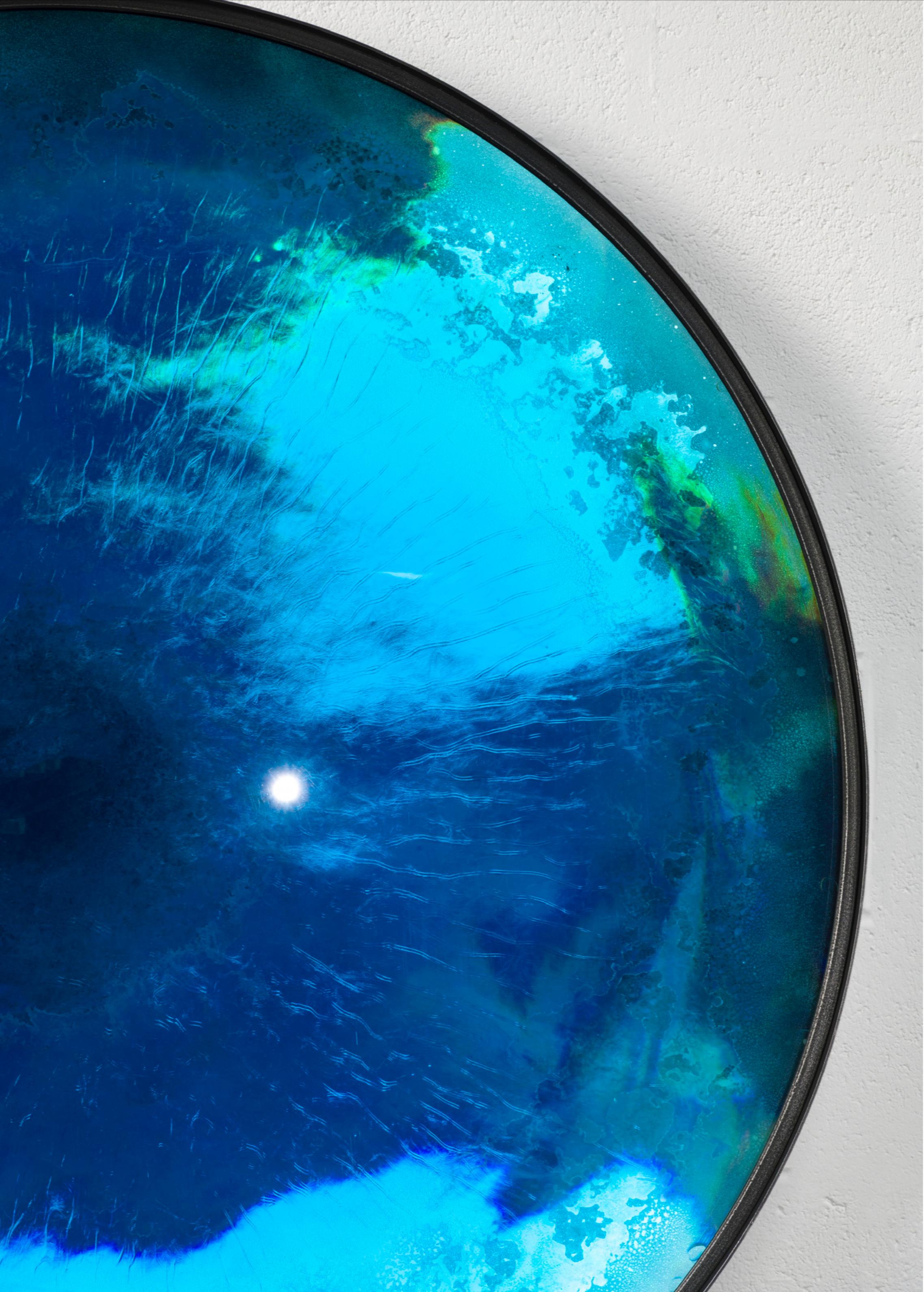 Aegean Iris mirror by Tom Palmer
Dimensions: D 140 x H 5 cm
Mterials: Glass, Resin
Also Available: Other sizes and variations available.

The Iris mirrors are hand cast in a high grade Polyurethane industrial resin that can be tinted to almost