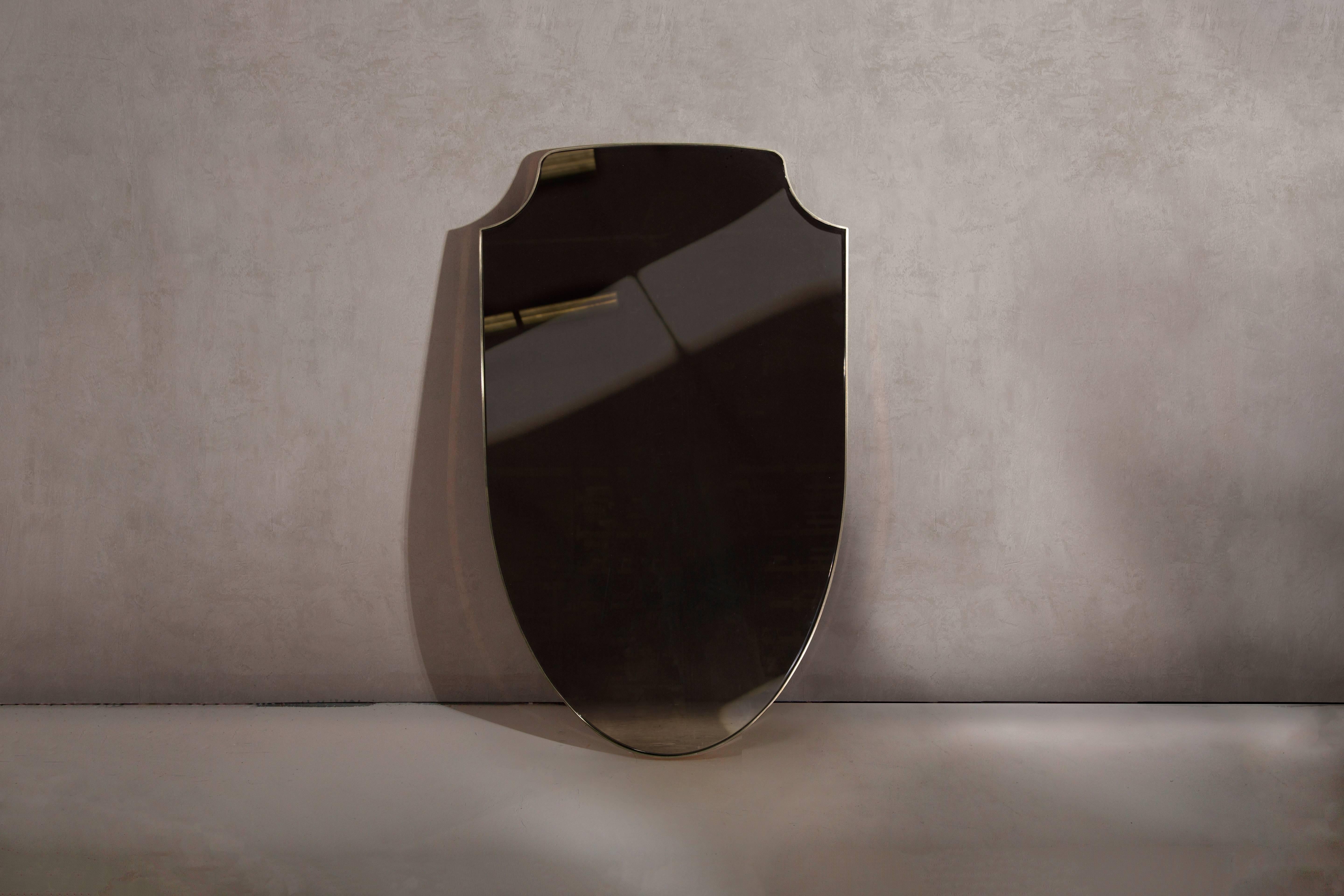 A wall mirror in polished brass and bronze tinted glass Hand crafted in the North to order. Custom sizes and finishes are available.

Supplied with two screw fixing points to rear face. Larger mirrors supplied with batten fixing.

Measures: 91.5cm H