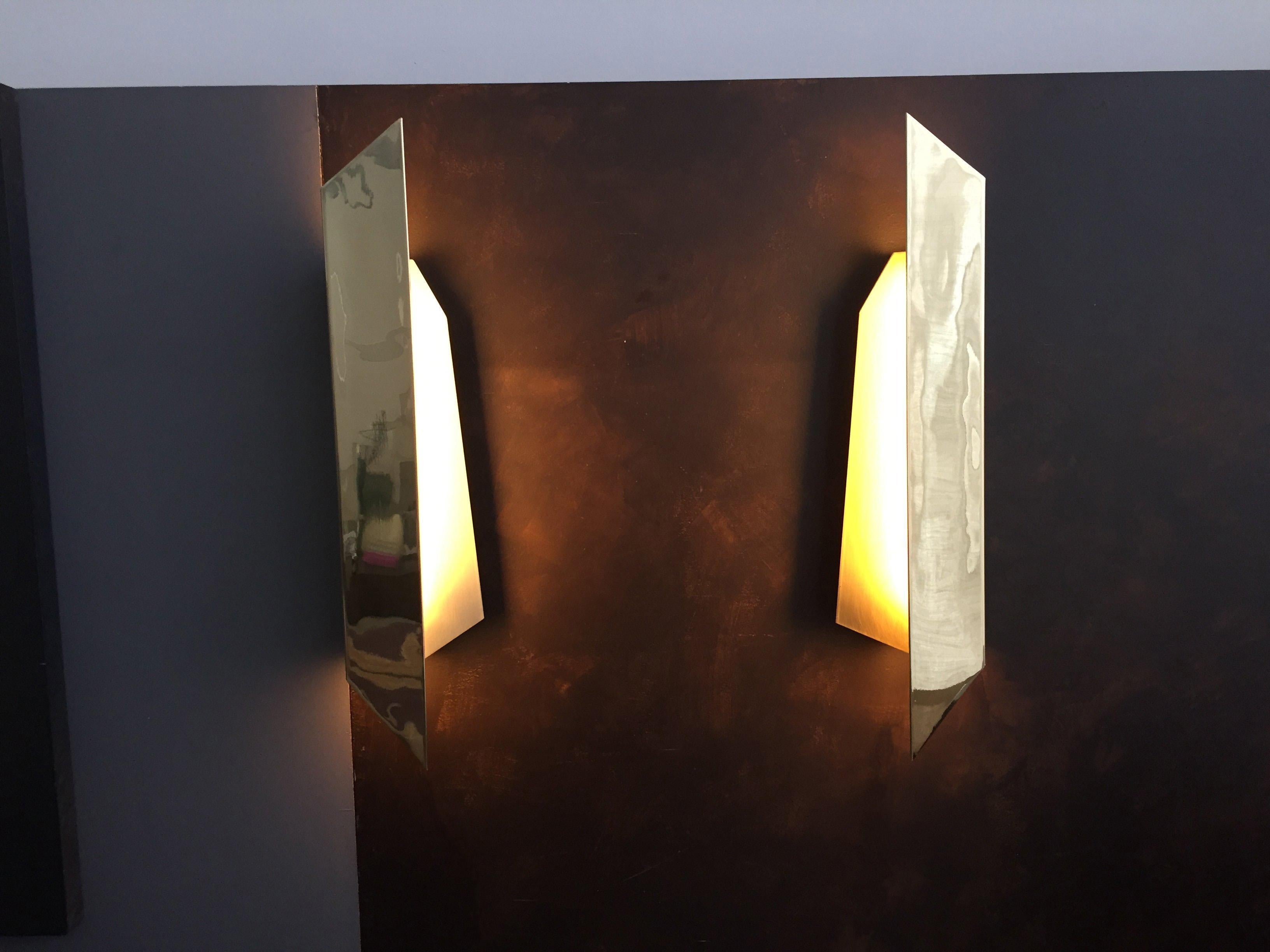Polished brass / satin brass / clear coated brass / glass

Contemporary brass wall lamp inspired by an airplane toy, made on child age using paper. Polished satin clear and coated brass, glass and led light.