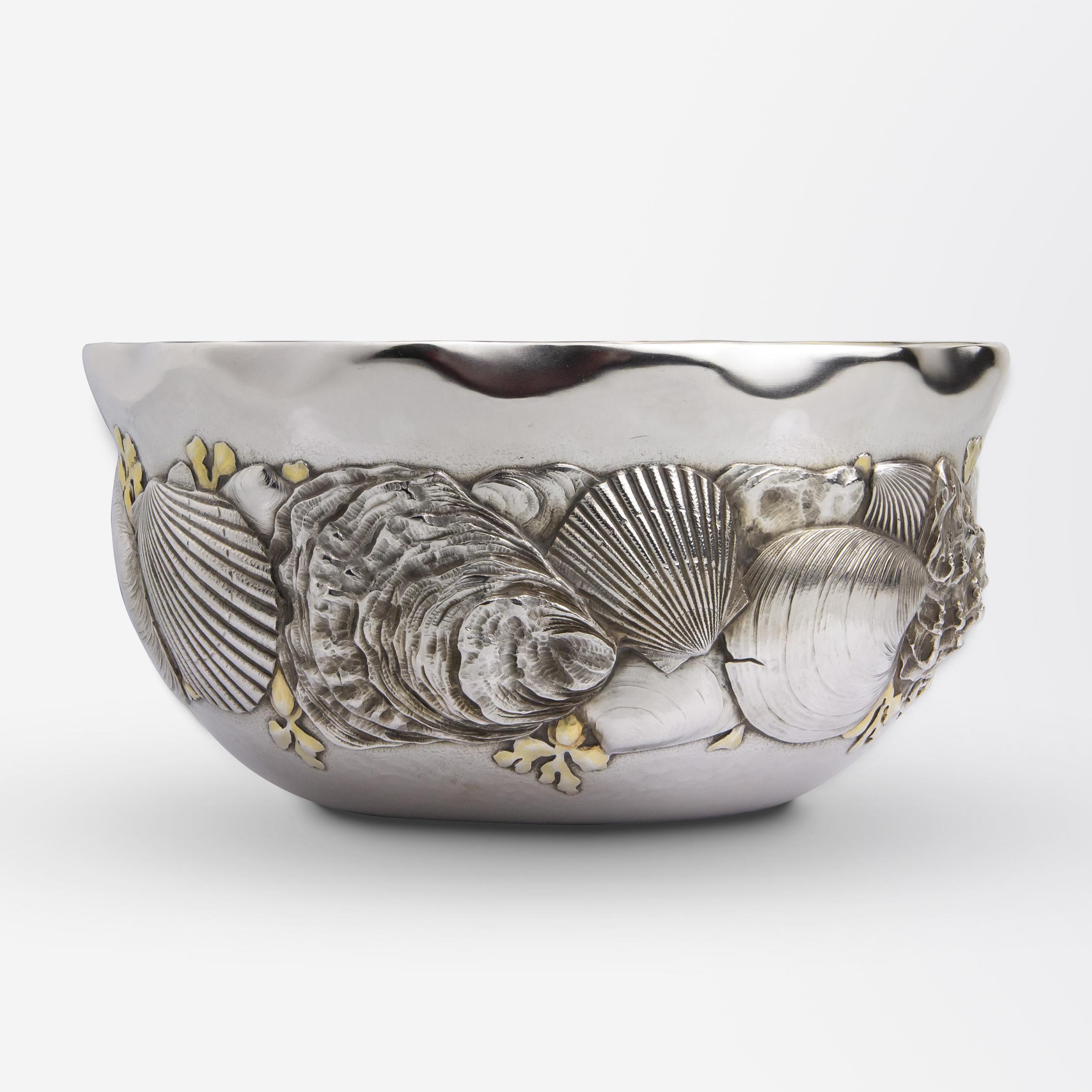This exceedingly rare silver bowl was made in the Aesthetic taste by Whiting Manufacturing Company. The sterling silver bowl features naturalistic repousse motifs of shells and seaweed, some of which are parcel gilt and feature the most incredible