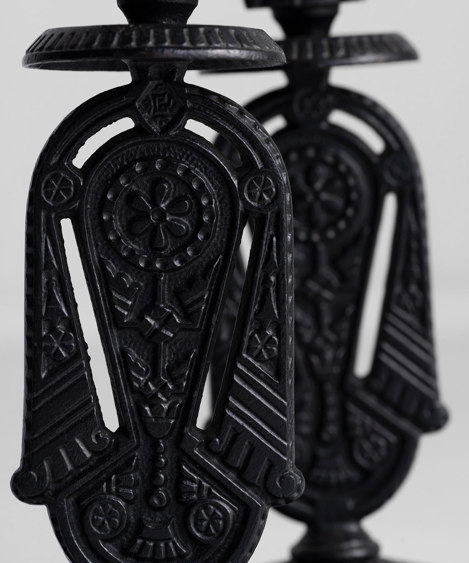 Cast iron candlesticks made in four parts with each section stamped with the registered design of Kitemark.