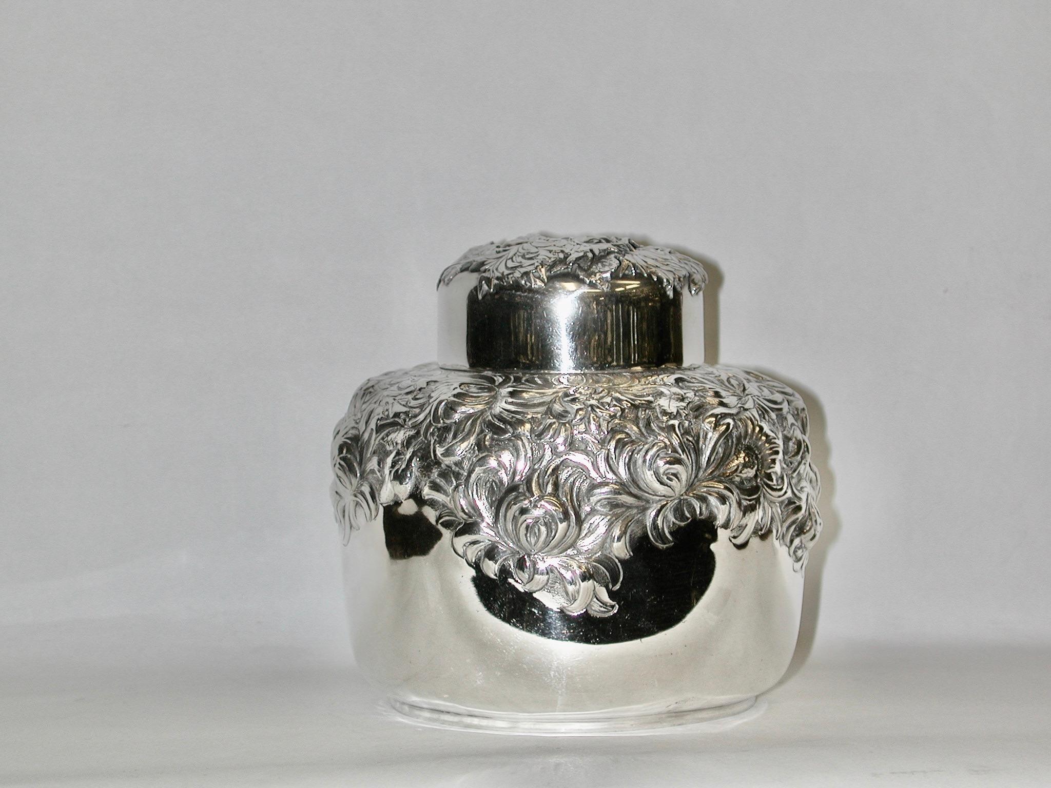 Aesthetic Japonesque sterling silver chrysanthemum tea caddy, Circa 1890, New York
Made by George W Sheibler in a heavy gauge of sterling silver.
Round with gently tapering sides and short neck with snug-fitting cover. 
Chased and applied