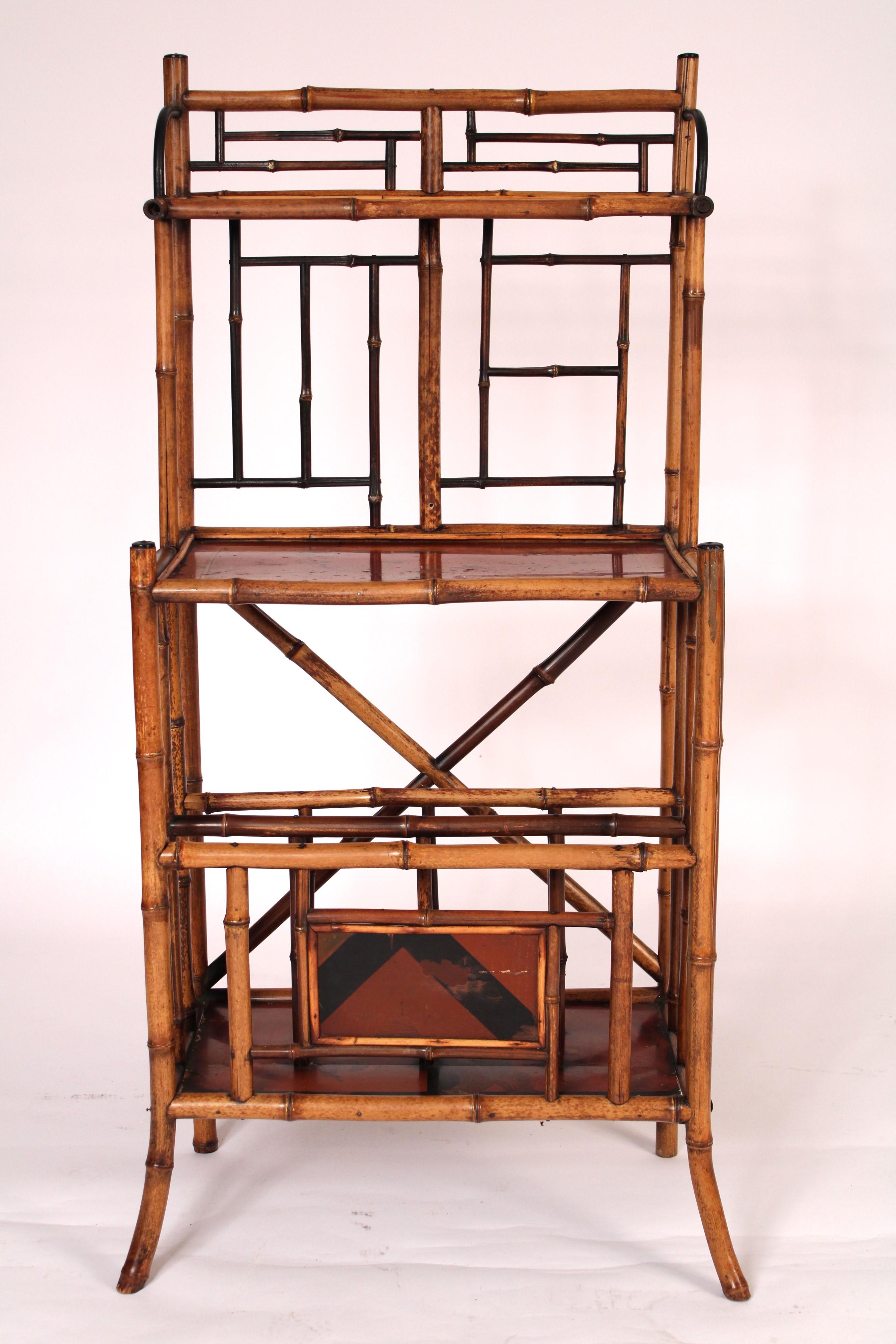 Aesthetic movement bamboo and lacquered etagere / canterbury, circa 1910. With bamboo frame work and lacquered panels. The lower section is a magazine rack.
