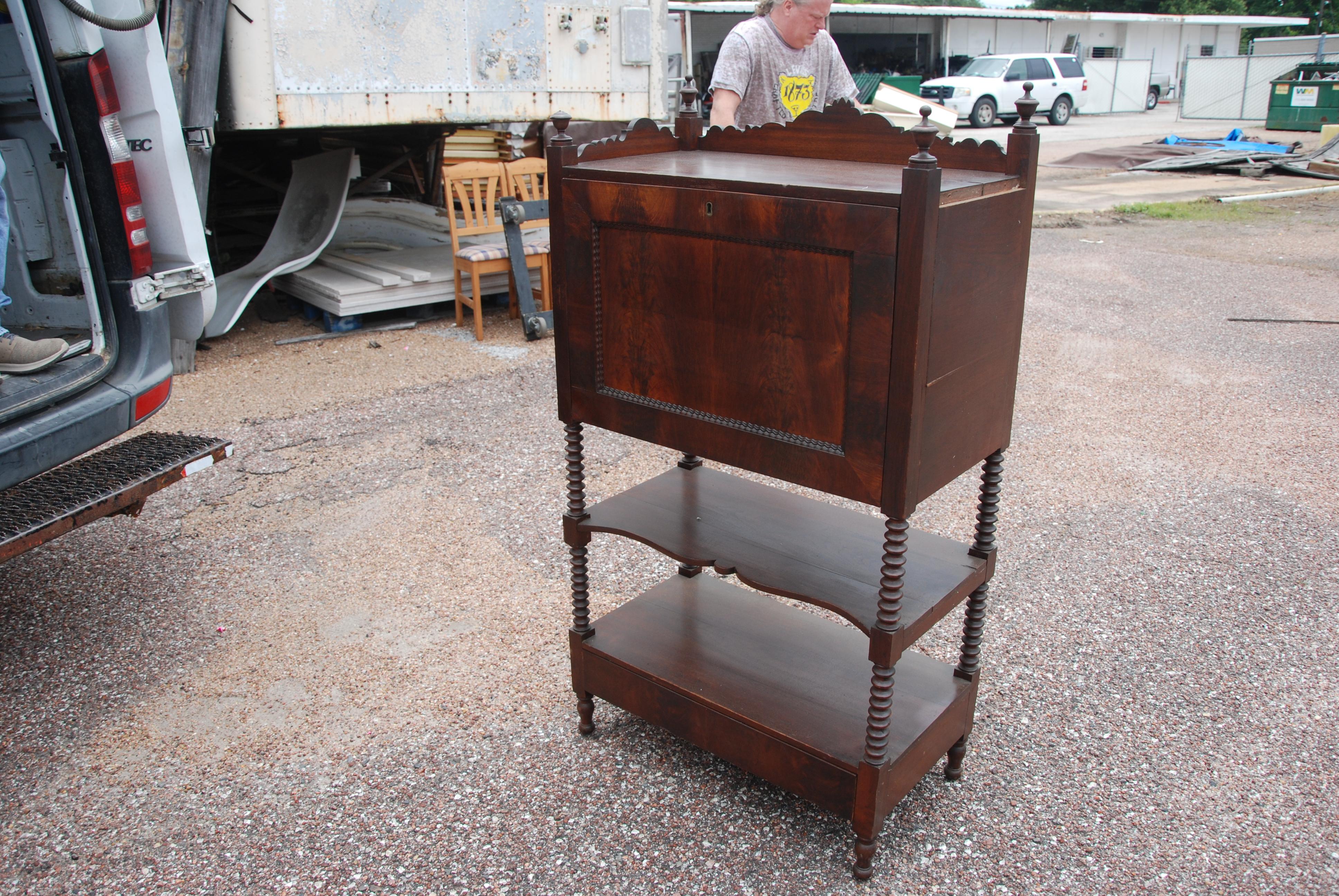 Bonheur du Jour secretary desk cabinet,
circa late 1880s.
 
Dark walnut with finial accents and turned legs. The hinged writing surface opens to reveal a fitted interior with 5 drawers and overhead mail slots. There are 2 shelves underneath and a