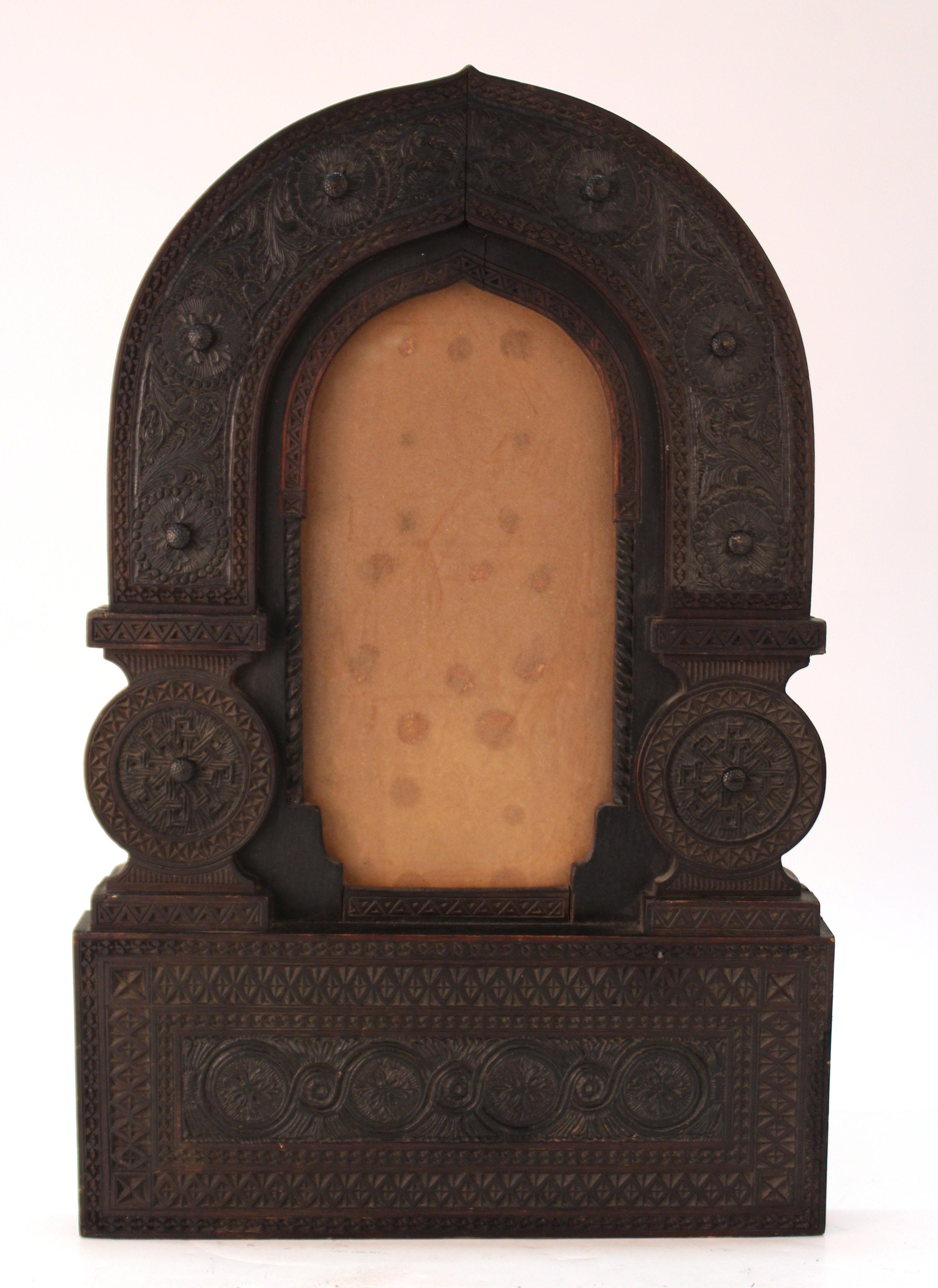 Aesthetic movement Moorish style picture frame in elaborately carved wood, reminiscent of the designs of Carlo Bugatti or Lockwood DeForest. The piece dates to circa 1880 and is in great vintage condition.