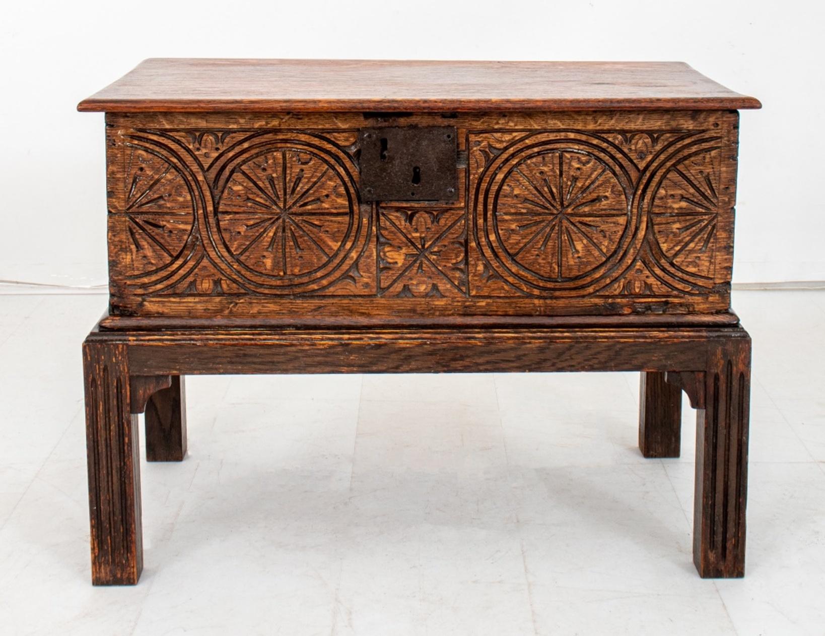 Aesthetic Movement hardwood side or end table with top opening to reveal storage compartment, the front hand-carved with a geometric design, upon four rectangular legs.

Dimensions: 19