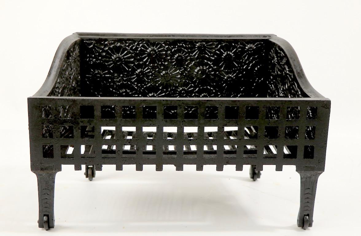 Charming Aesthetic Movement fireplace insert grate with raised flower motif casting. This example is in very good, clean, ready to use condition, free of breaks, cracks or repairs. American made in by C. B. Evans of Cincinnati Ohio, circa 1880s
